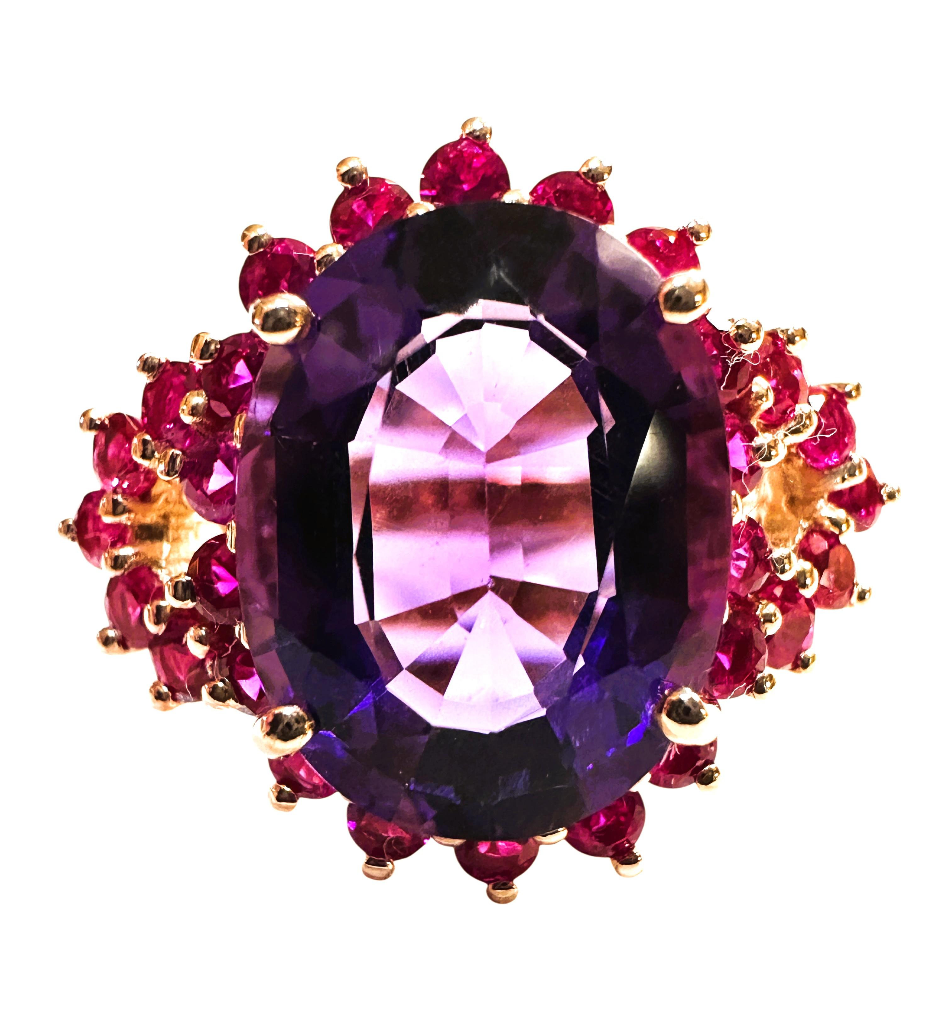 This is just a beautiful ring.  The stone is from Brazil.  It is a high-quality stone and is 7.80 carats.  The stone is surrounded by pink sapphires, and they circle around the sides on the band.  The color combination is fabulous.  They are all set