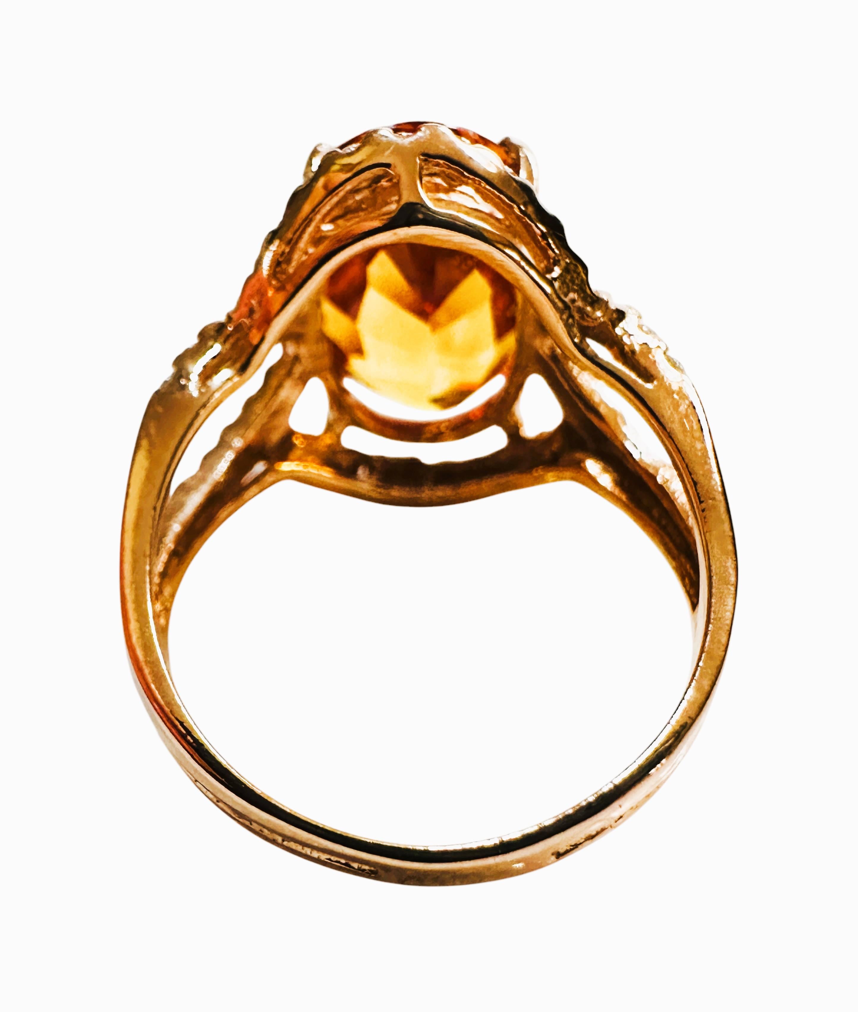 This is a very fetching ring.  This stone is from Sri Lanka and just a beautiful shade of dark yellow..  It has a bit of orange in it.  The ring is a size 6.5.   It is a fancy oval cut stone and is 13.7 x 9.5 mm and is surrounded by diamond cut