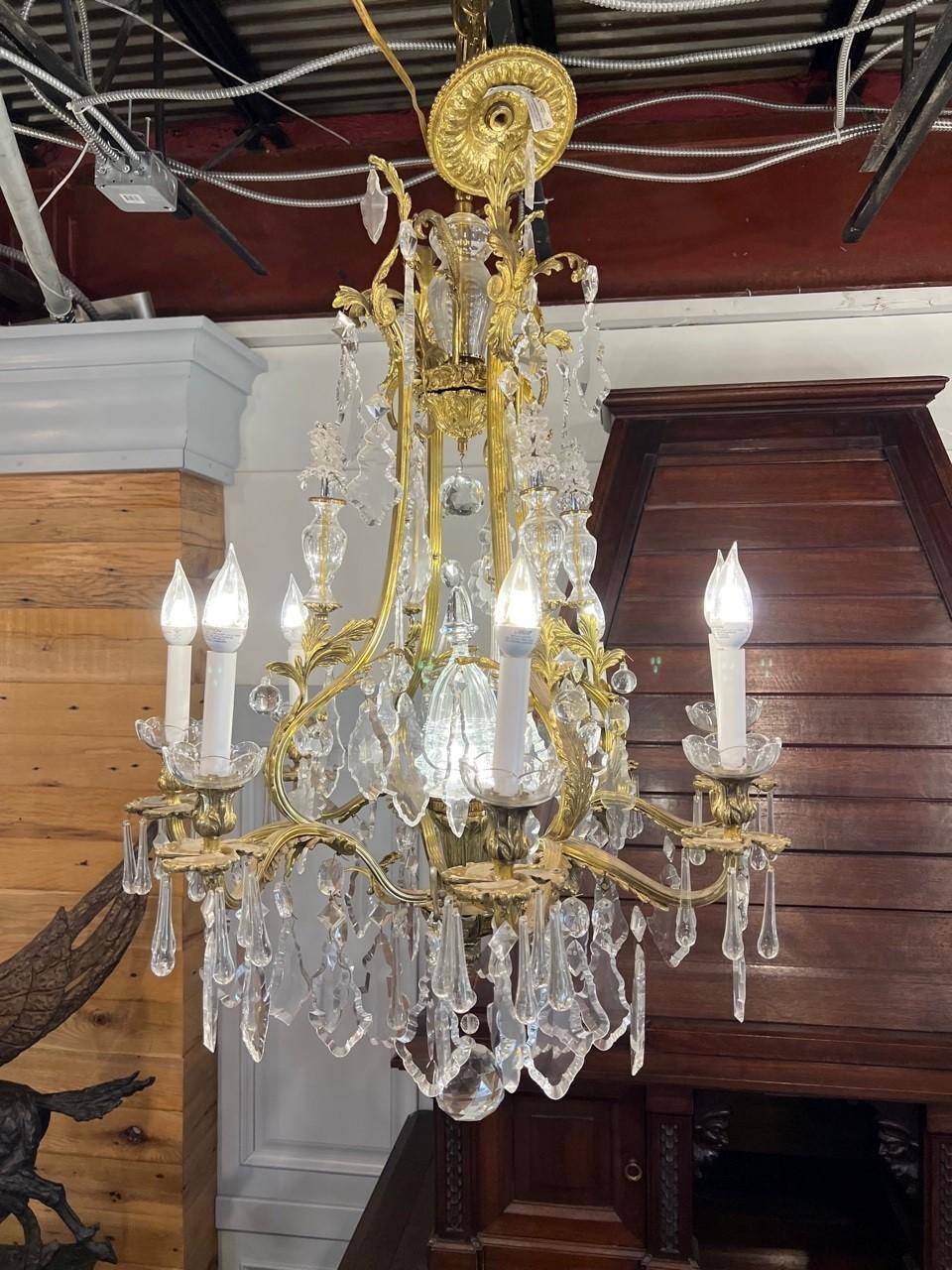 Beautiful 8 arm brass and Bohemian hand cut crystal chandelier with a antique brass finish. With its nine lights one on each arm and one in the center the cut crystal is just beautiful when lit. This is a new chandelier never hung that was brought