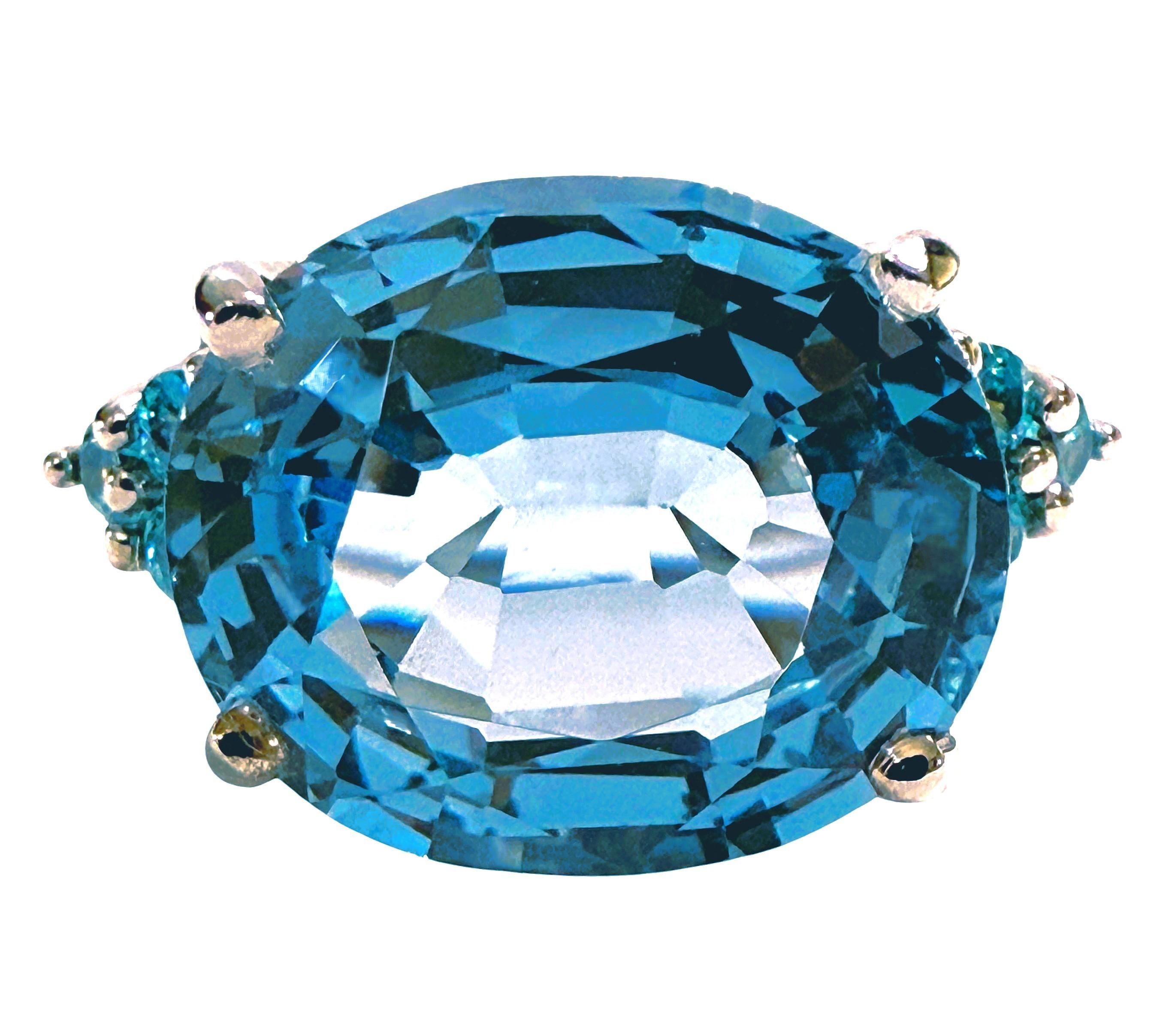 The stone is from Africa and is just exquisite. The stone is a Baby Blue Topaz and is 8.0 carats.  The stone is a fancy oval cut stone and measures 13 x 11 mm and is flanked by 3 diamond cut aqua sapphires on either side.  The color combination is