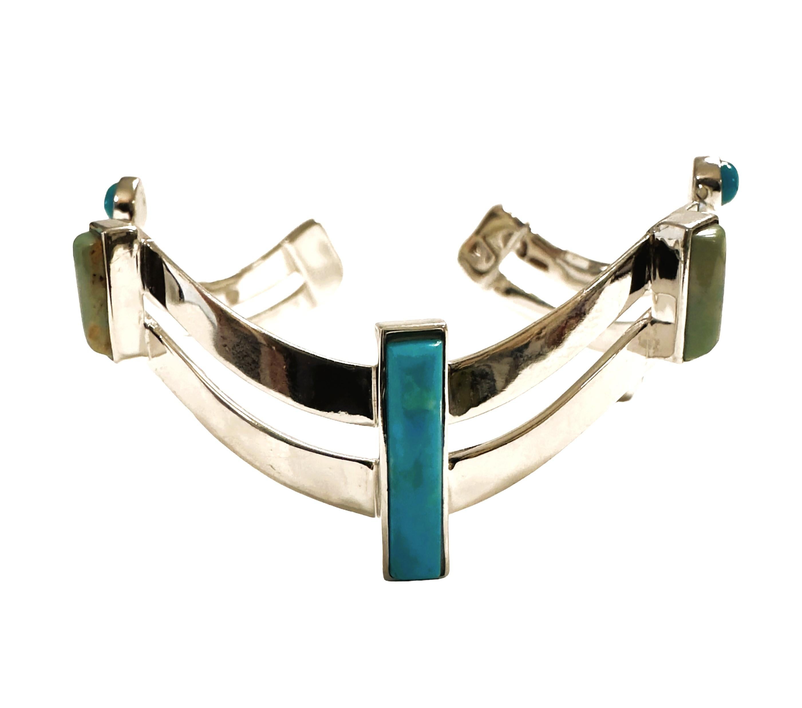 What a beautiful bracelet!   The bracelet is 2.25 inches wide and very flexible and will easily fit any size wrist.  It has beautiful round and rectangle turquoise stones and 2 rectangle moss agate stones.  Perfect for summer. It is stamped 925. 