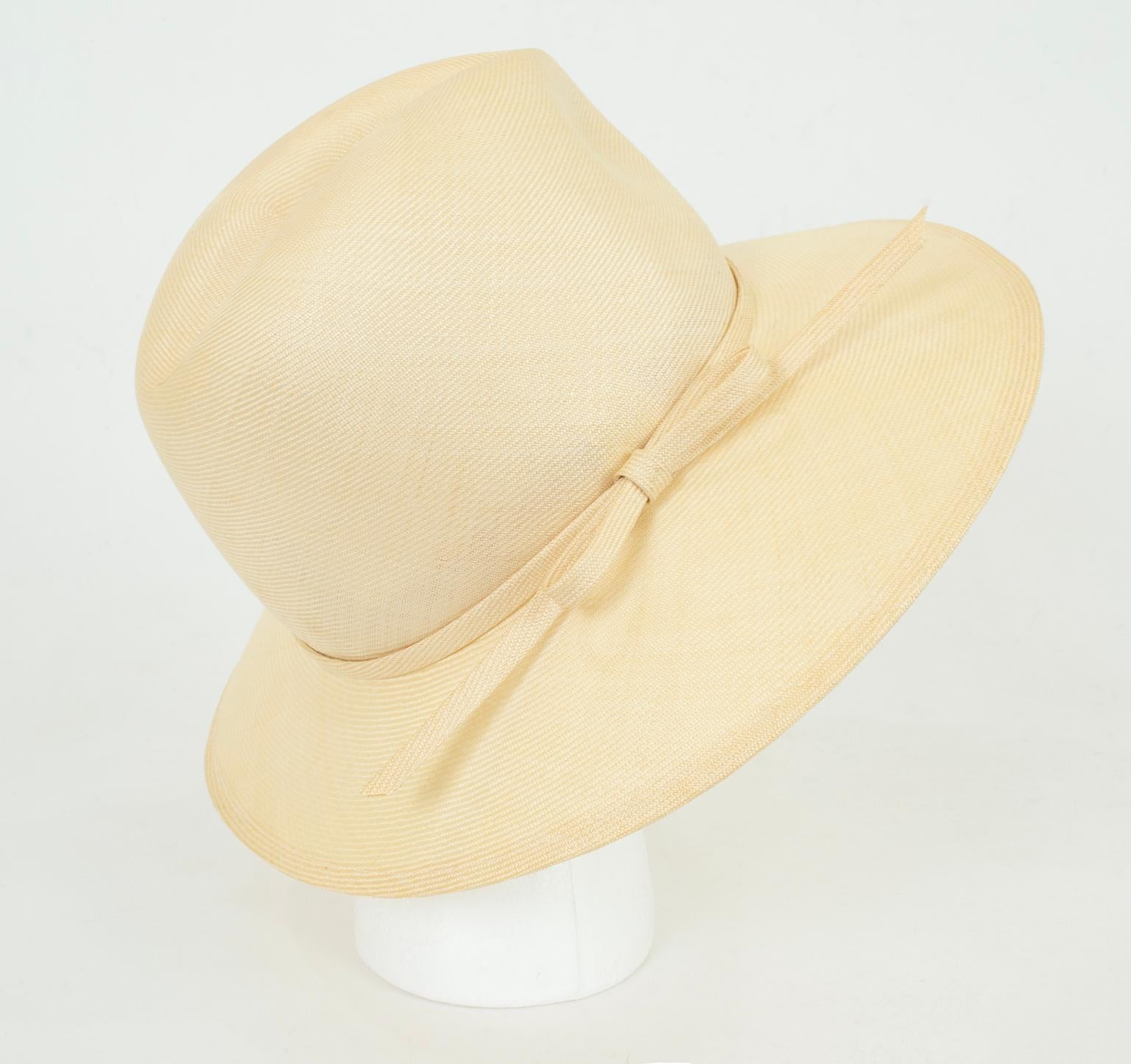 Never worn in its original box, this 70-year-old hat is still as modern, relevant and chic as it was when it was first made. Fashioned of ultra-lightweight, tightly-woven ivory straw, it features a traditional Panama crown with an extra wide,