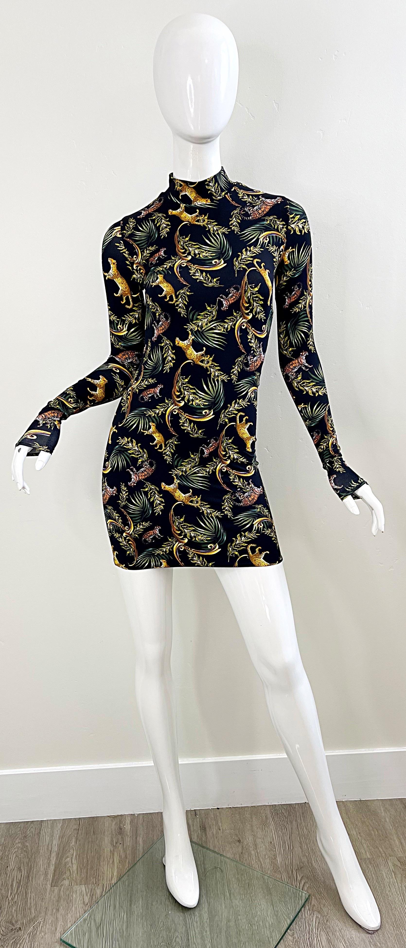 Sexy brand new ADRIANA IGLESIAS cheetah / leopard novelty print long sleeve bodcon mini dress ! Palm leaves printed amongst the cheetahs and leopards. Simply slips over the head, and stretches to fit. Pair with wedges, sandals or flats for day, or