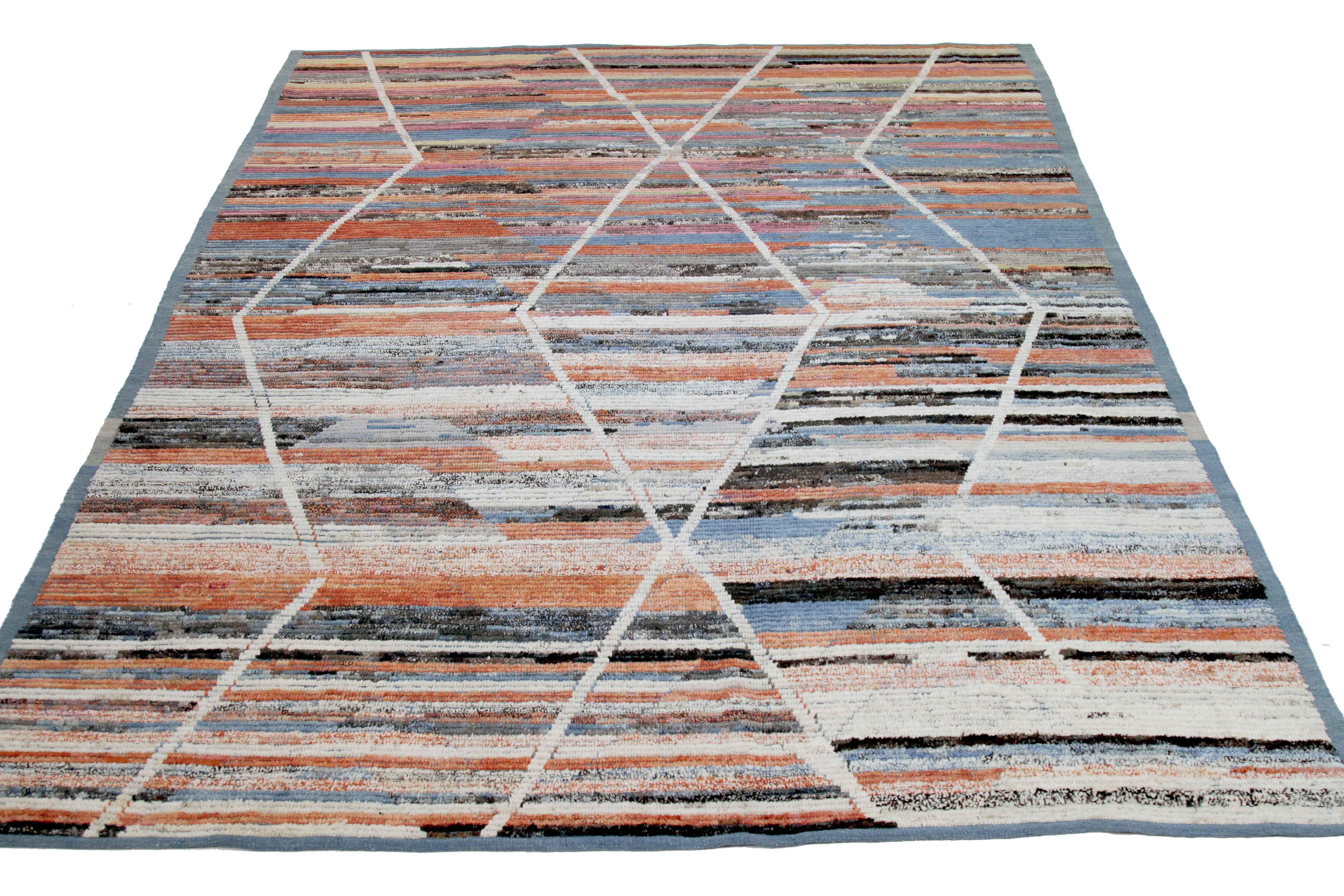 Modern Afghan rug handwoven from the finest sheep’s wool and colored with all-natural vegetable dyes that are safe for humans and pets. It’s a traditional Afghan weaving featuring a Moroccan inspired design highlighted by colored streaks and white