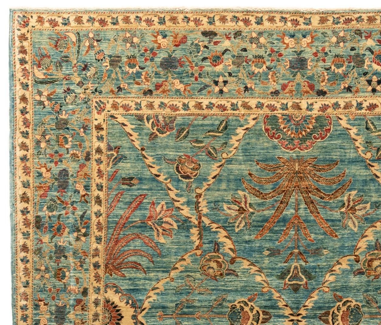 This newly woven square, room-size rug features a delicate floral design against a blue field. The abrash (irregularly dyed yarn) of the field gives a worn, antique appearance. Handwoven in Afghanistan.