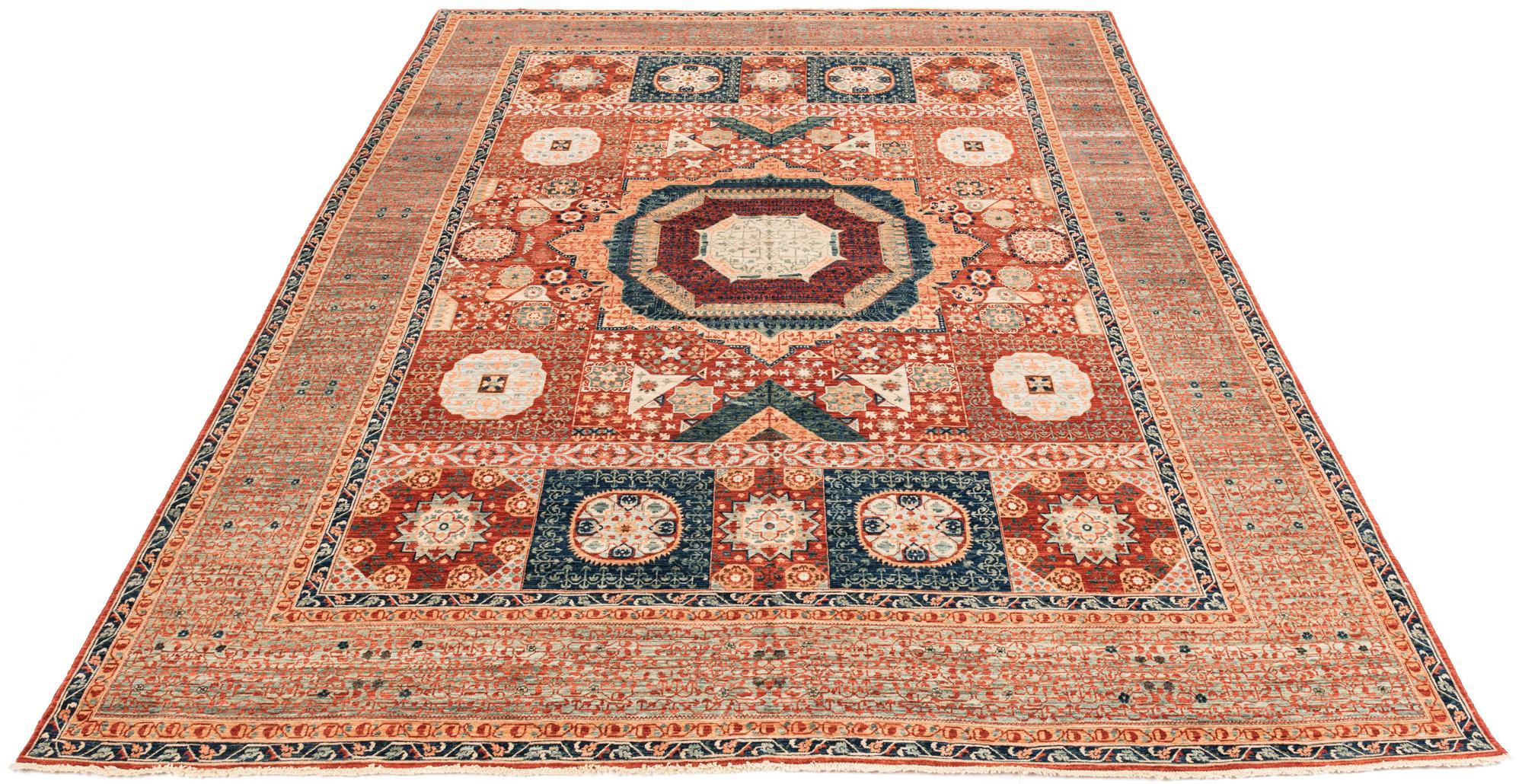 This transitional handwoven rug has both flora and geometric motifs. The influence of Persian rug design is apparent in the rug.  Size:  9.3 x 11.10