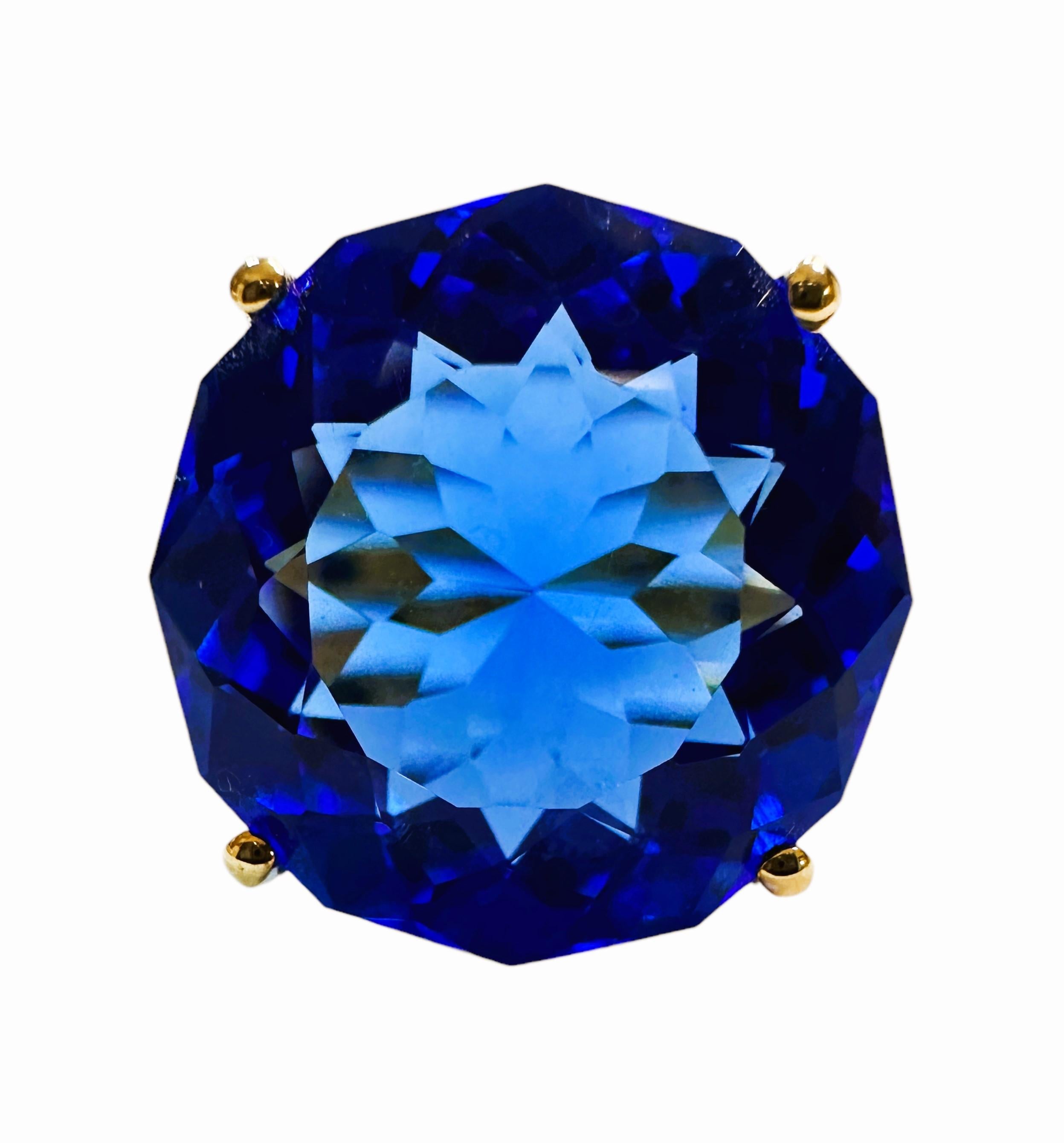 I love the color of this stone.  It is just so brilliant.  The ring is a size 6.75.  The stone is from Africa and is just exquisite.  It is a round cut stone and is 13.6 Cts.   The main stone is 16 mm and  has diamond cut white sapphire stones on