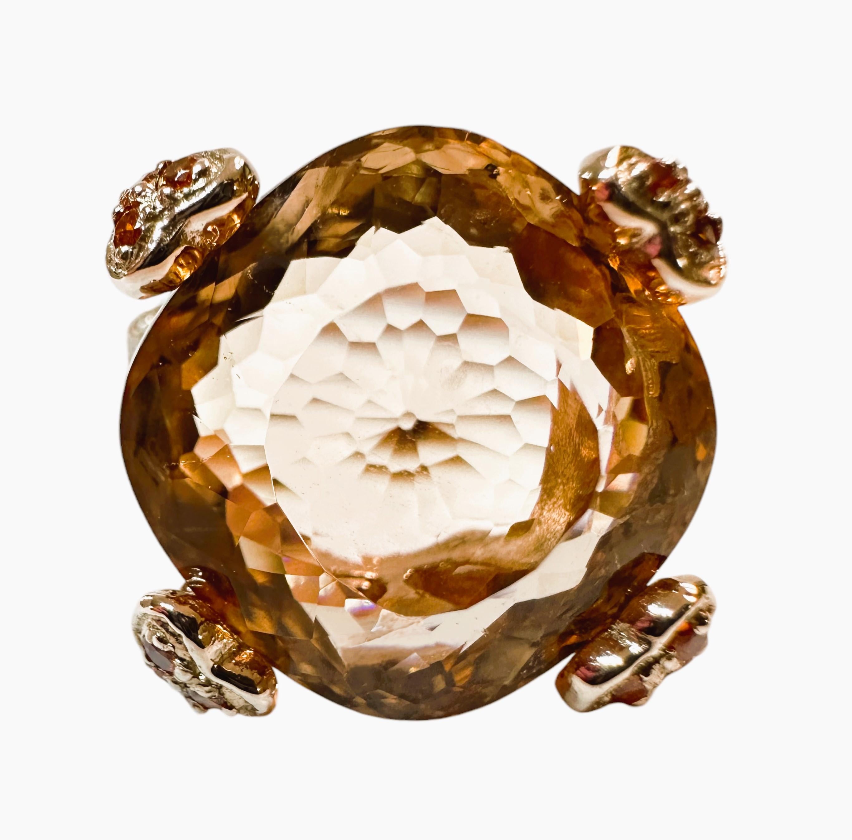 This ring is just beautiful. The ring is a size 6.5.   The stone is from Africa and is just exquisite.  It is a very high quality stone.  It is a cushion cut stone and is 13.60 Cts   The main stone is 15 x 15 mm and has diamond cut orange sapphires
