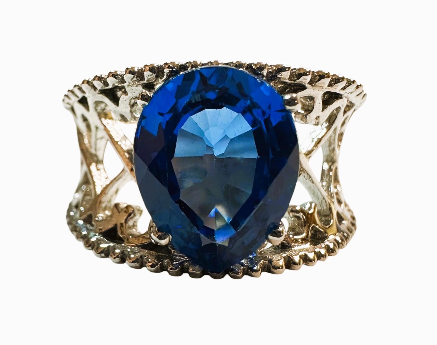 I love the color of this stone.  It is just so brilliant.  The ring is a size 6.75.  The stone is from Africa and is just exquisite.  It is a pear cut stone and is 8.5 Cts.   The main stone is  11 x 9mm and placed in a beautiful filigree setting. 