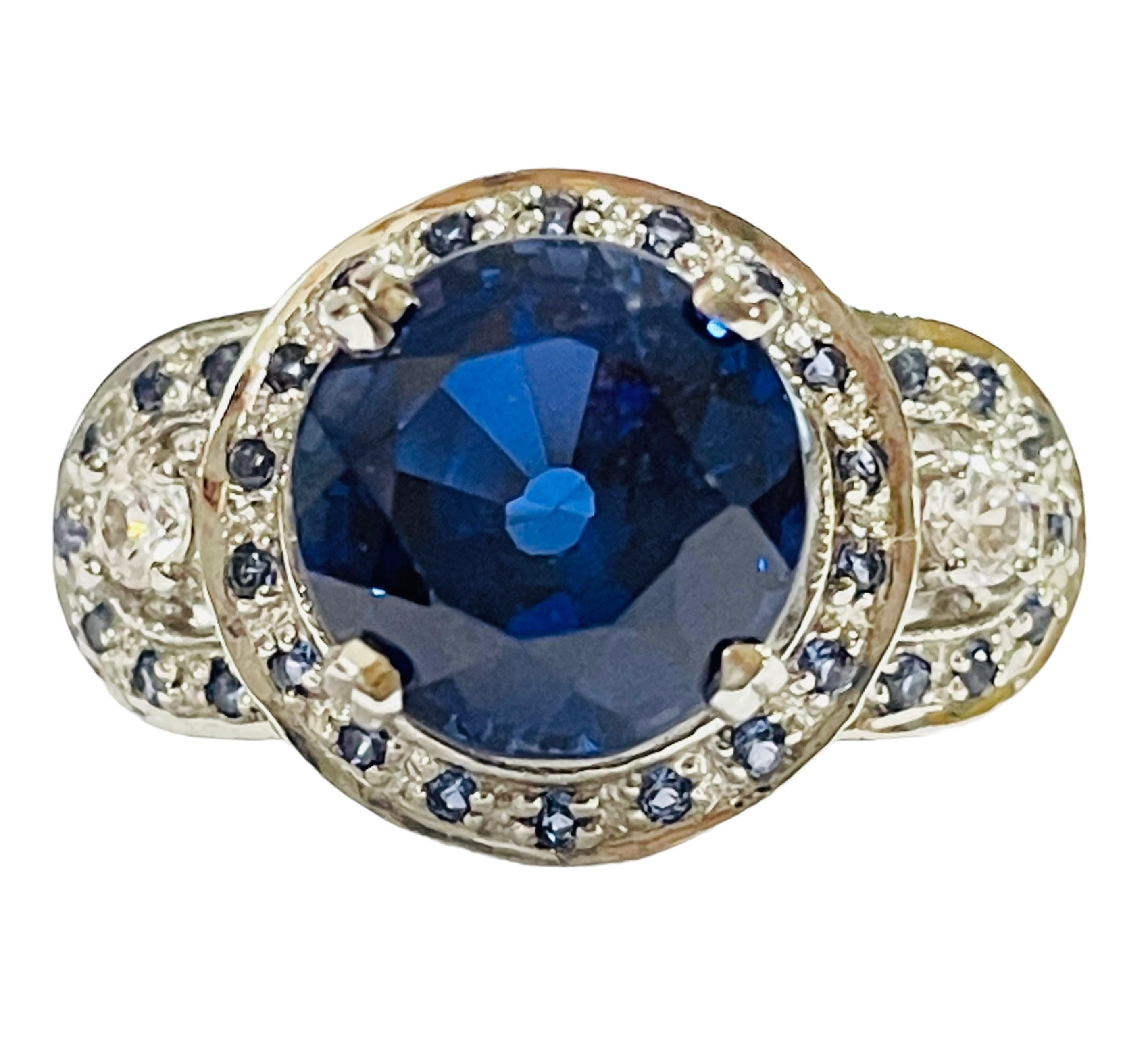 The ring is a size 6.5.  The stone is from Africa and is just exquisite. It is a round cut stone and is 3.10 Cts.   The main stone is 8.7 mm. It is surrounded by smaller Blue Sapphires and White Sapphires and they run down the band as well.  The