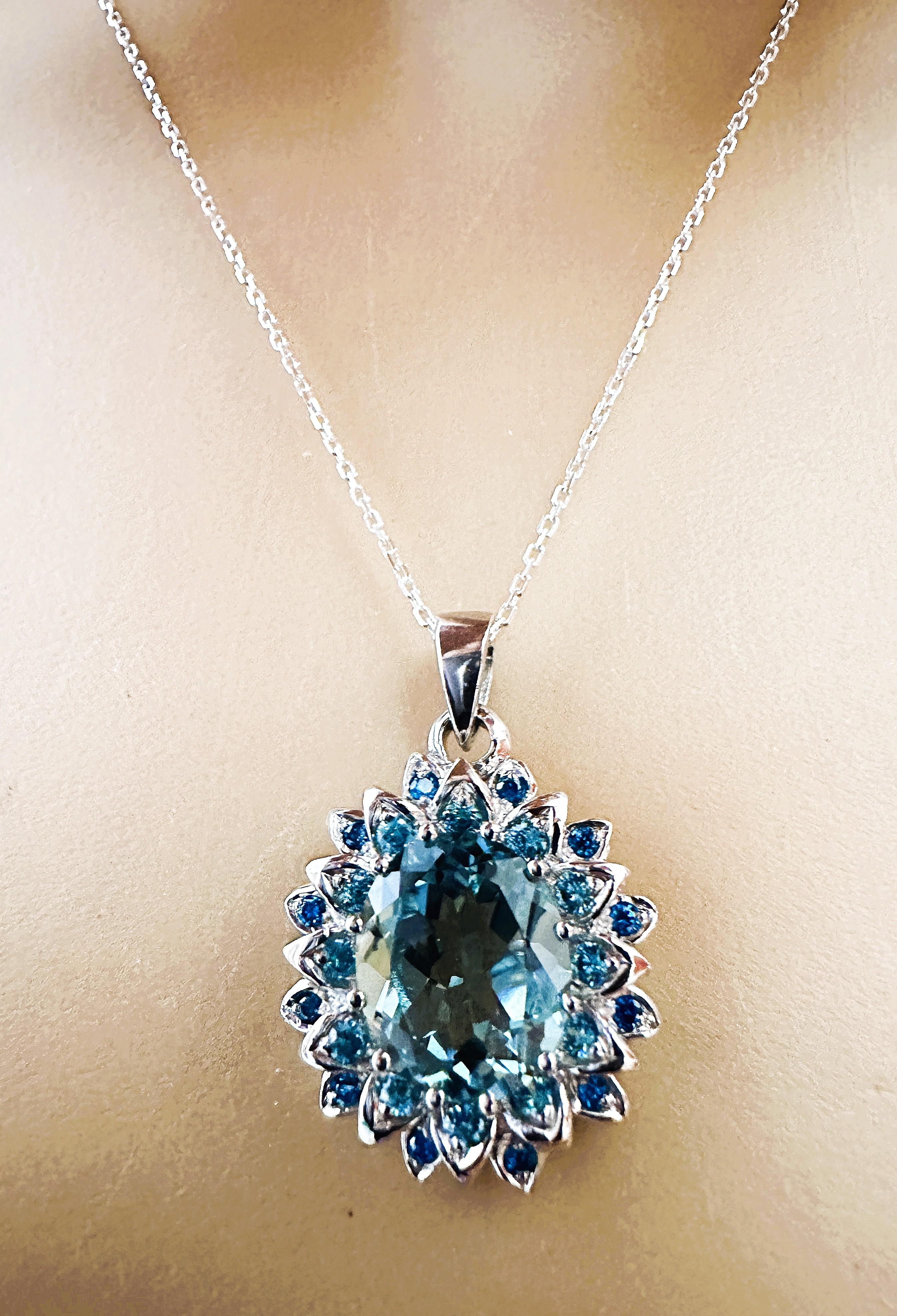 This is a  beautiful necklace.  The stone is from Brazil.  It's a gorgeous deep aquamarine stone.  I just love this color.  It is a beautiful oval cut stone and is 12 x 10 mm and is 4.42 cts.  The stone is surrounded by diamond cut aqua sapphires.