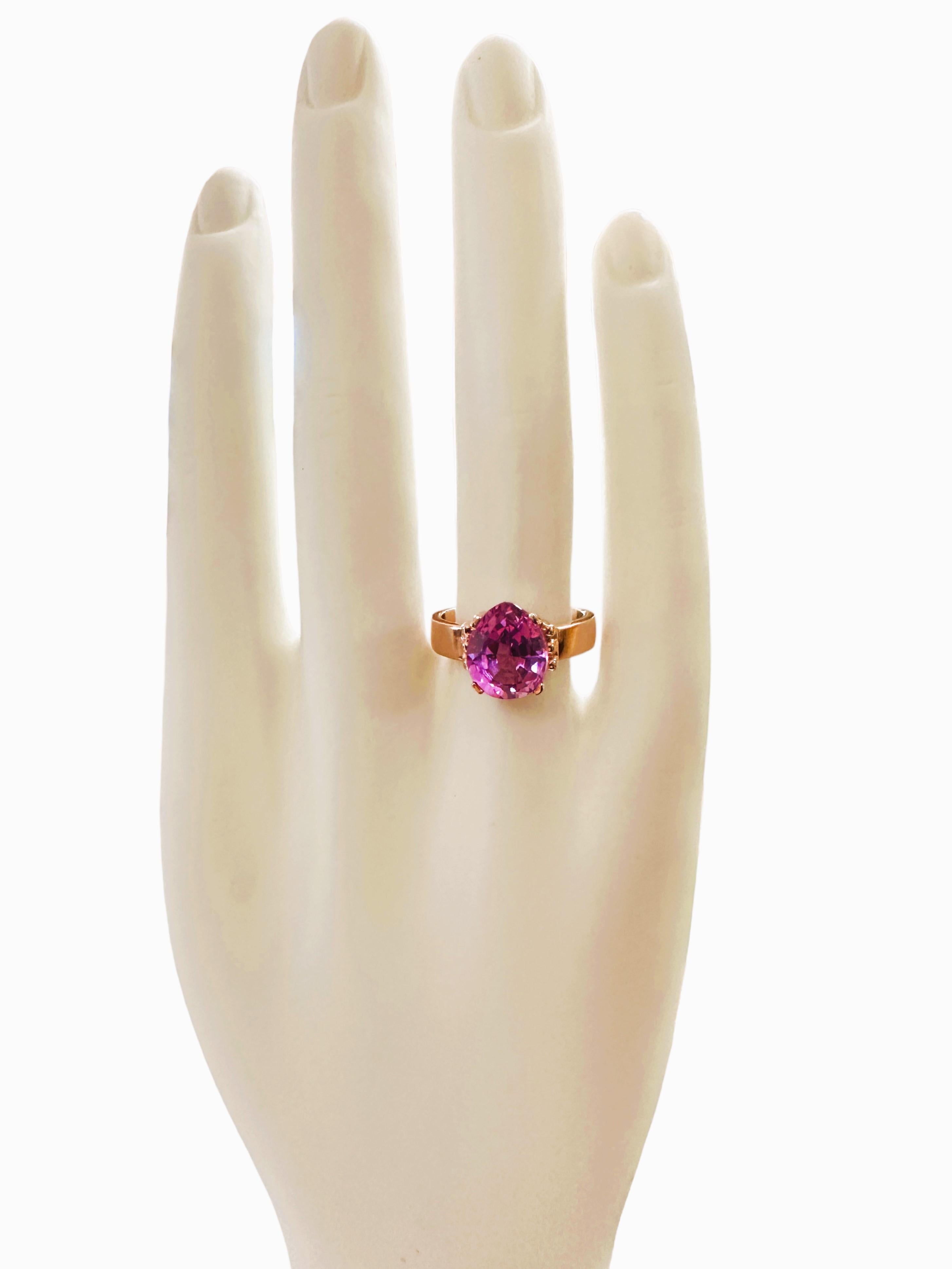 What a gorgeous ring!  The ring is a size 7.25.  The stone is from Africa and is just exquisite. It is an pear cut stone and is 5.5 Cts   The main stone is 11 x 9 mm. It has diamond cut Pink Sapphire stones that flank  either side of the stone. 