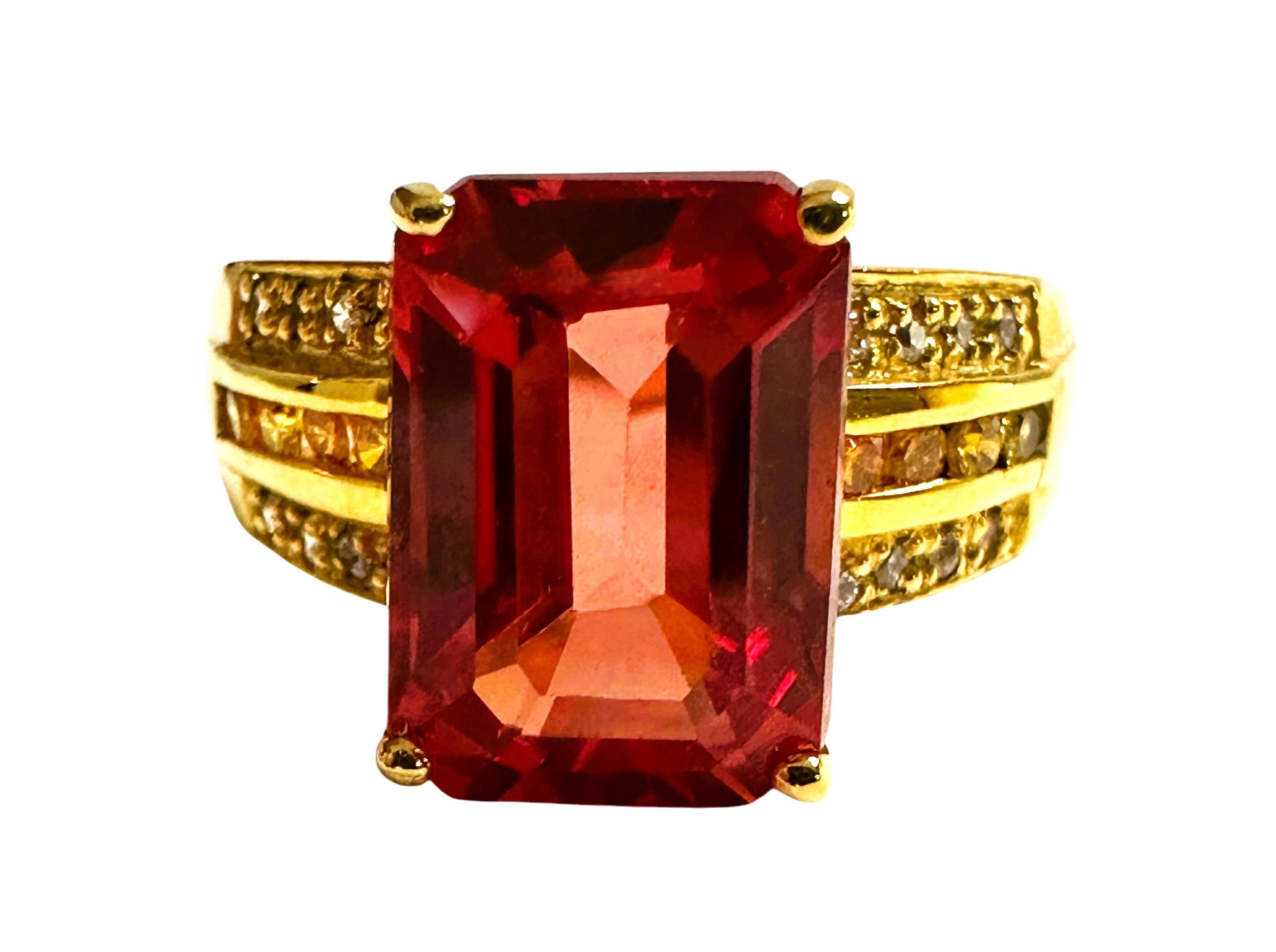 What a gorgeous ring! The ring is a size 6.  The stone is from Africa and is just exquisite.  It is an emerald cut stone and is 5.14 Ct   The main stone is 11 x 7.8 mm and has a diamond cut orange and white sapphires running down the band in 3 rows