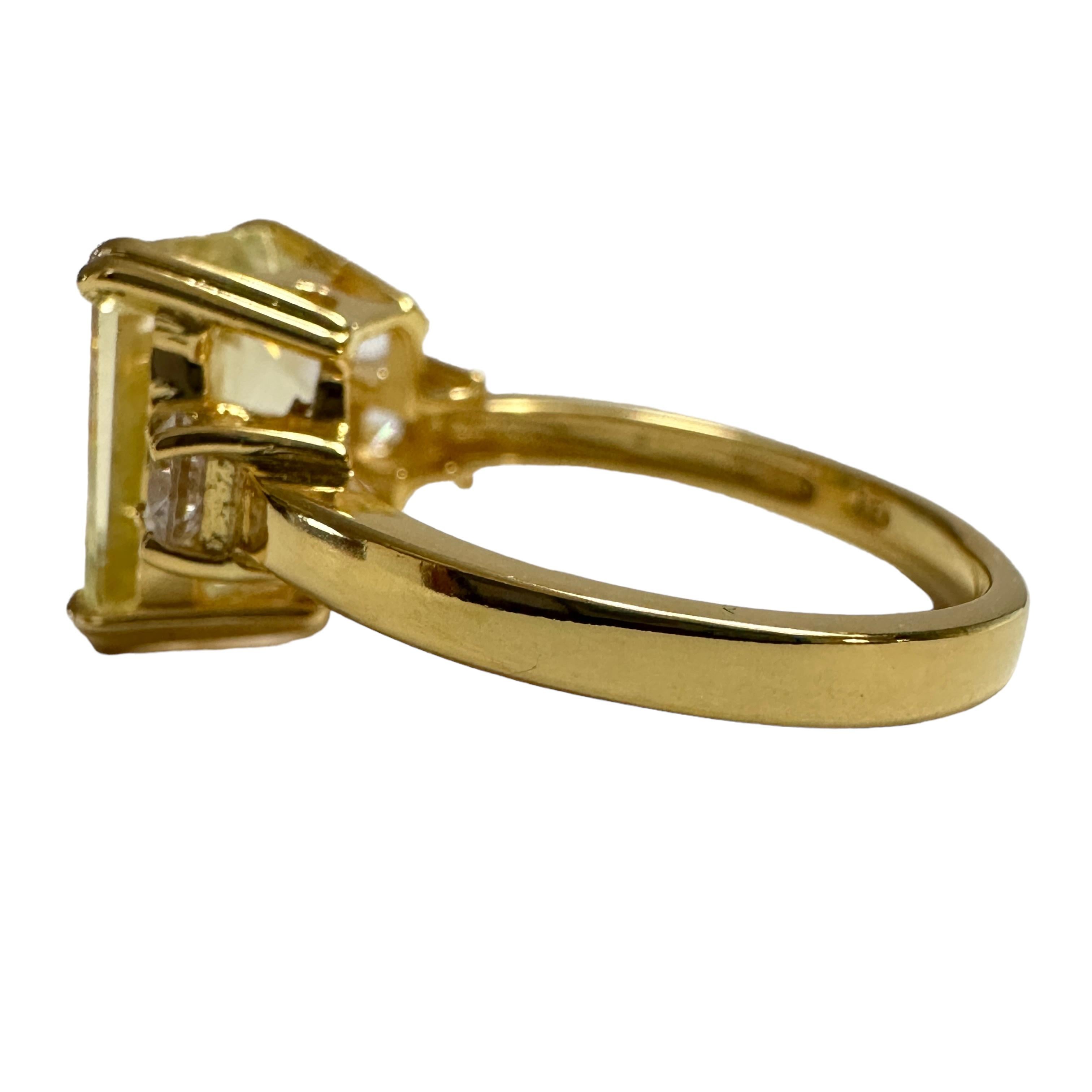 This stone was mined in the Africa. The setting is beautiful yellow gold plating which really compliments the stone.  The ring is a size 6.   It is an emerald cut stone and is 11 x 9 mm.  The main stone is flanked by Diamond Cut White Sapphires. 