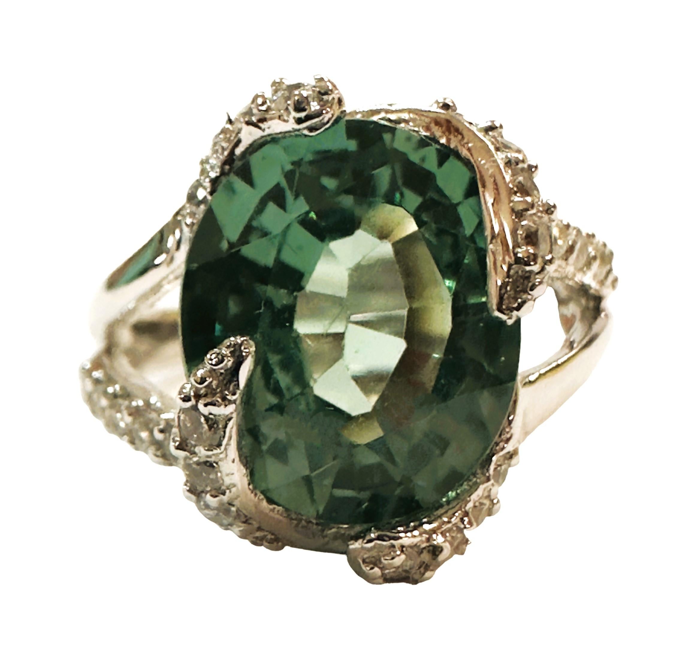 What a beautiful ring this is!.  I just love the design.  It is a size 6.5.  It is from Africa and is a very high quality stone.  The stone is an  oval cut stone and is 5.5 cts.   The main stone measures 12 x 10 mm and is surrounded by diamond cut