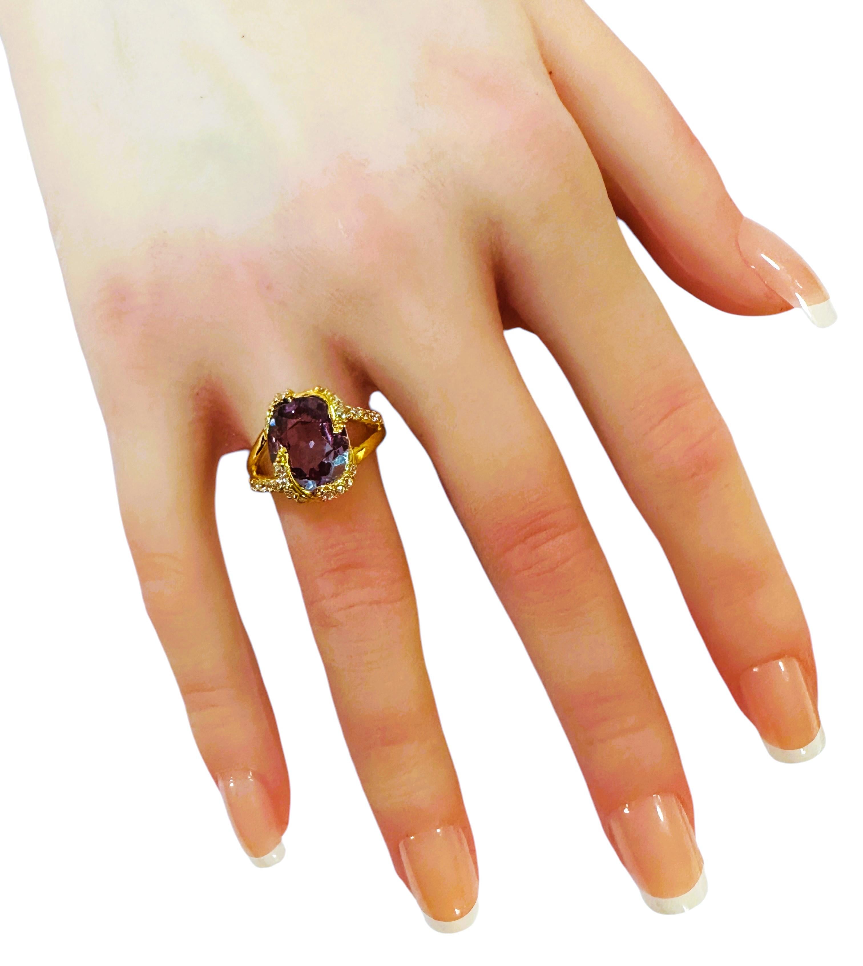 What a beautiful ring this is!.  I just love the design.  It is a size 6.25.  It is from Africa and is a very high quality stone.  The stone is an  oval cut stone and is 5.70 cts.   The main stone measures 12 x 10 mm and is surrounded by diamond cut