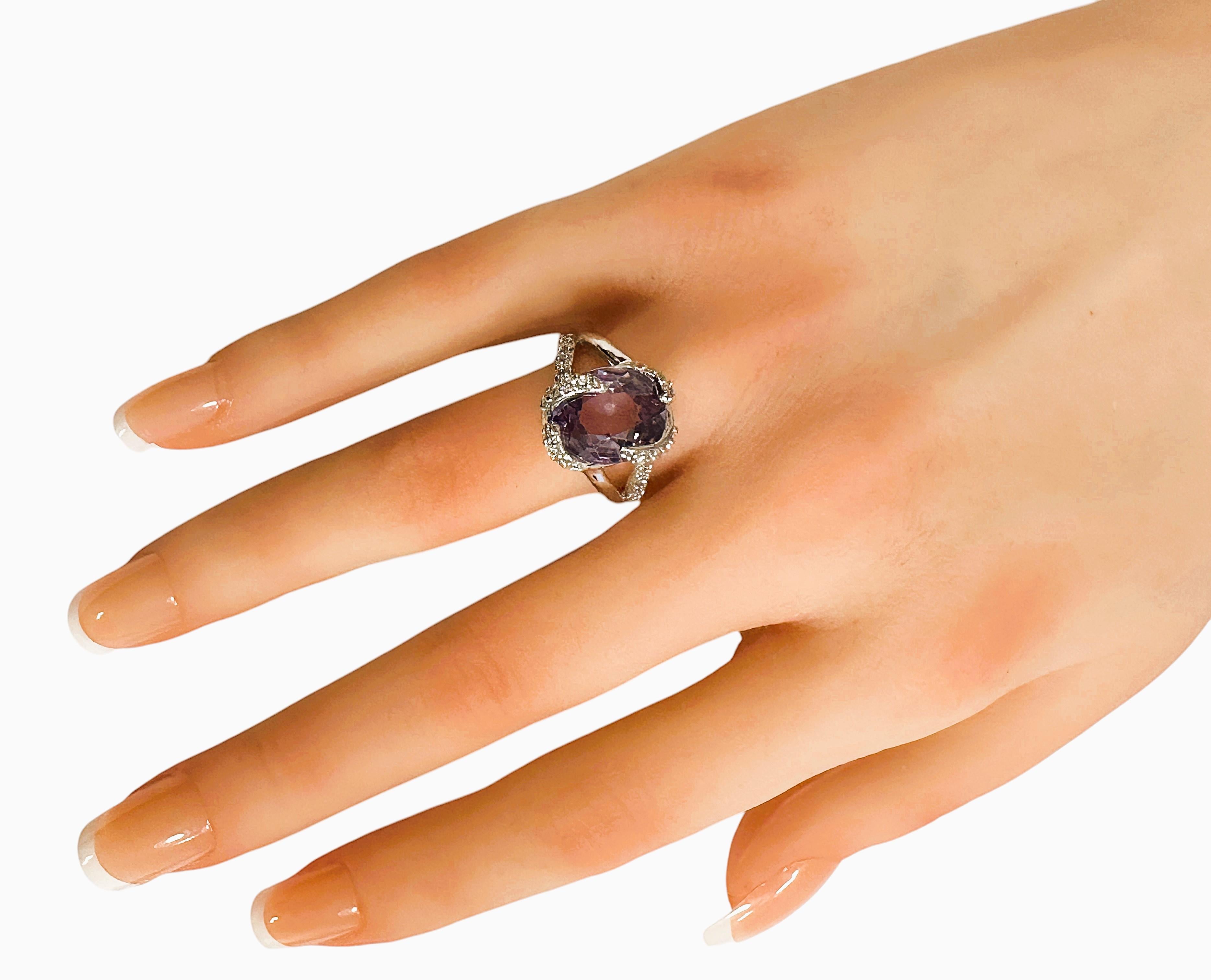 What a beautiful ring this is!.  I just love the design.  It is a size 6.25.  It is from Africa and is a very high quality stone.  The stone is a fancy oval cut stone and is 6 cts.   The main stone measures 12 x 10 mm and is surrounded by diamond