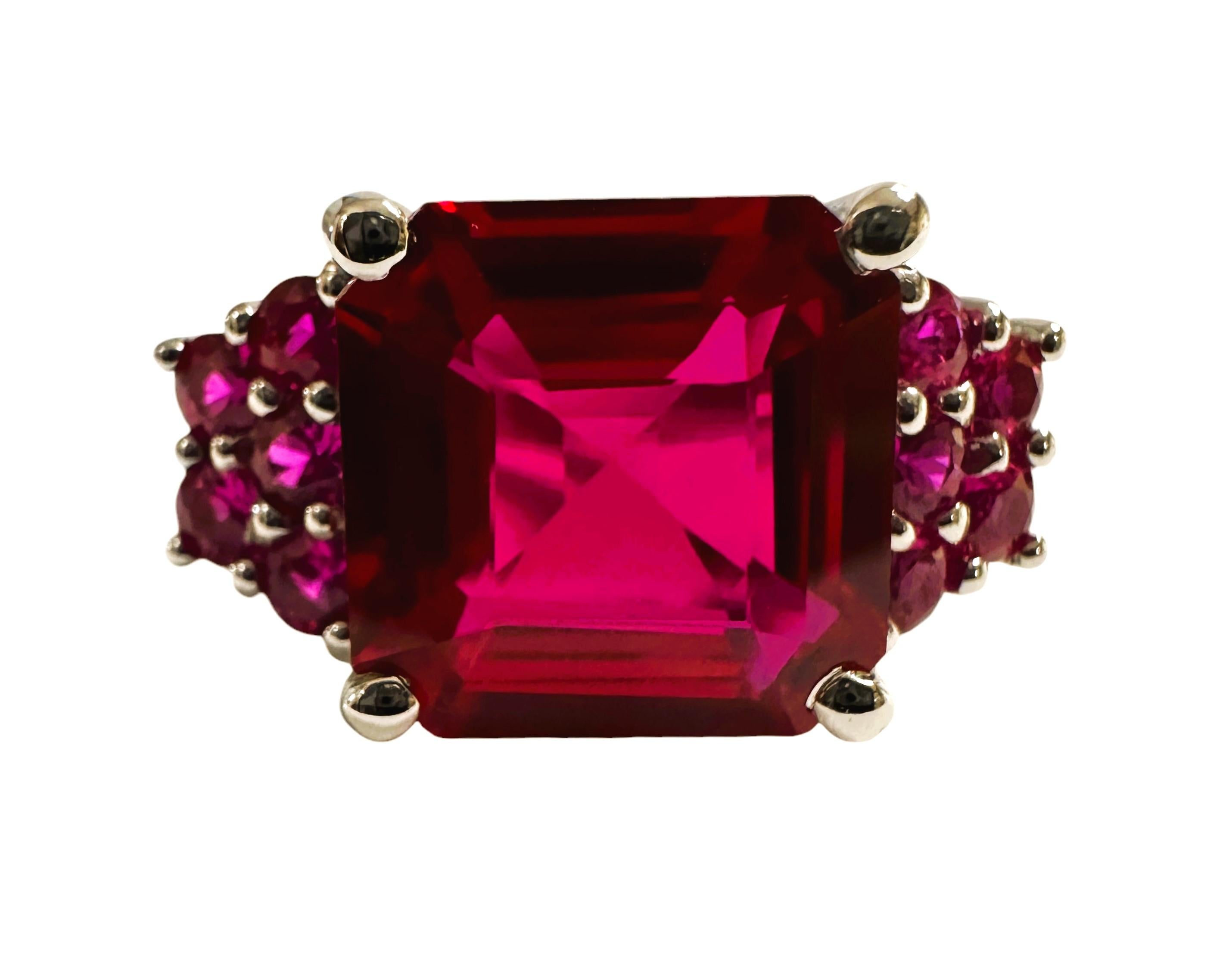 What a gorgeous ring!  The ring is a size 5.75.  The stone is from Africa and is just exquisite. It is an asscher cut stone and is 6.0 Cts   The main stone is 10.7 x 10.7 mm. It has diamond cut Pink Sapphire stones on either side of the band.  What