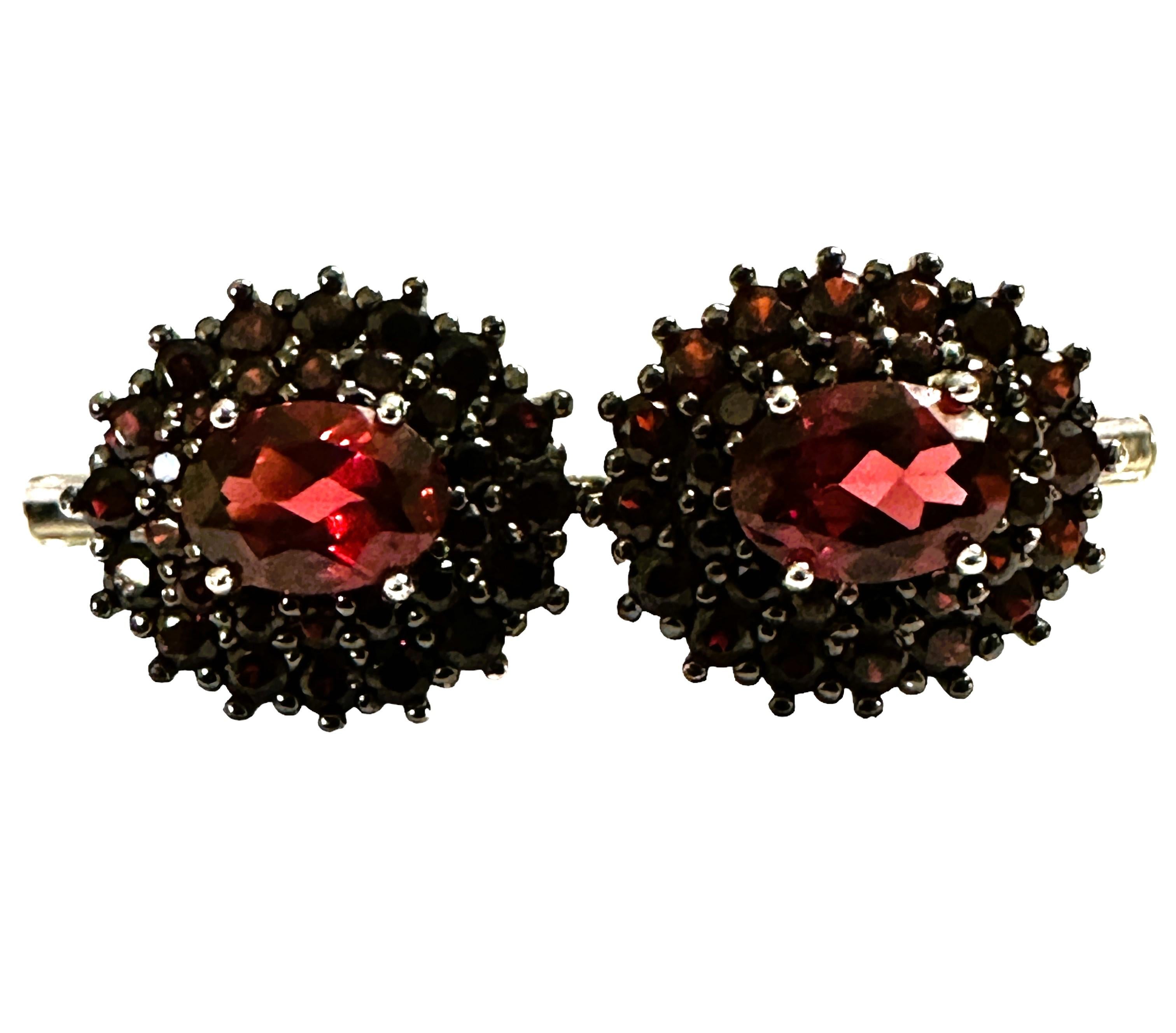 What beautiful colors in these earrings!   I just love the they have such rich colors.  It is a highly rated stone.  It is a oval cut stone and is .76 Cts   The main stone is 7 x 5 mm and has Diamond Cut Red Garnets surrounding the stone.   A very