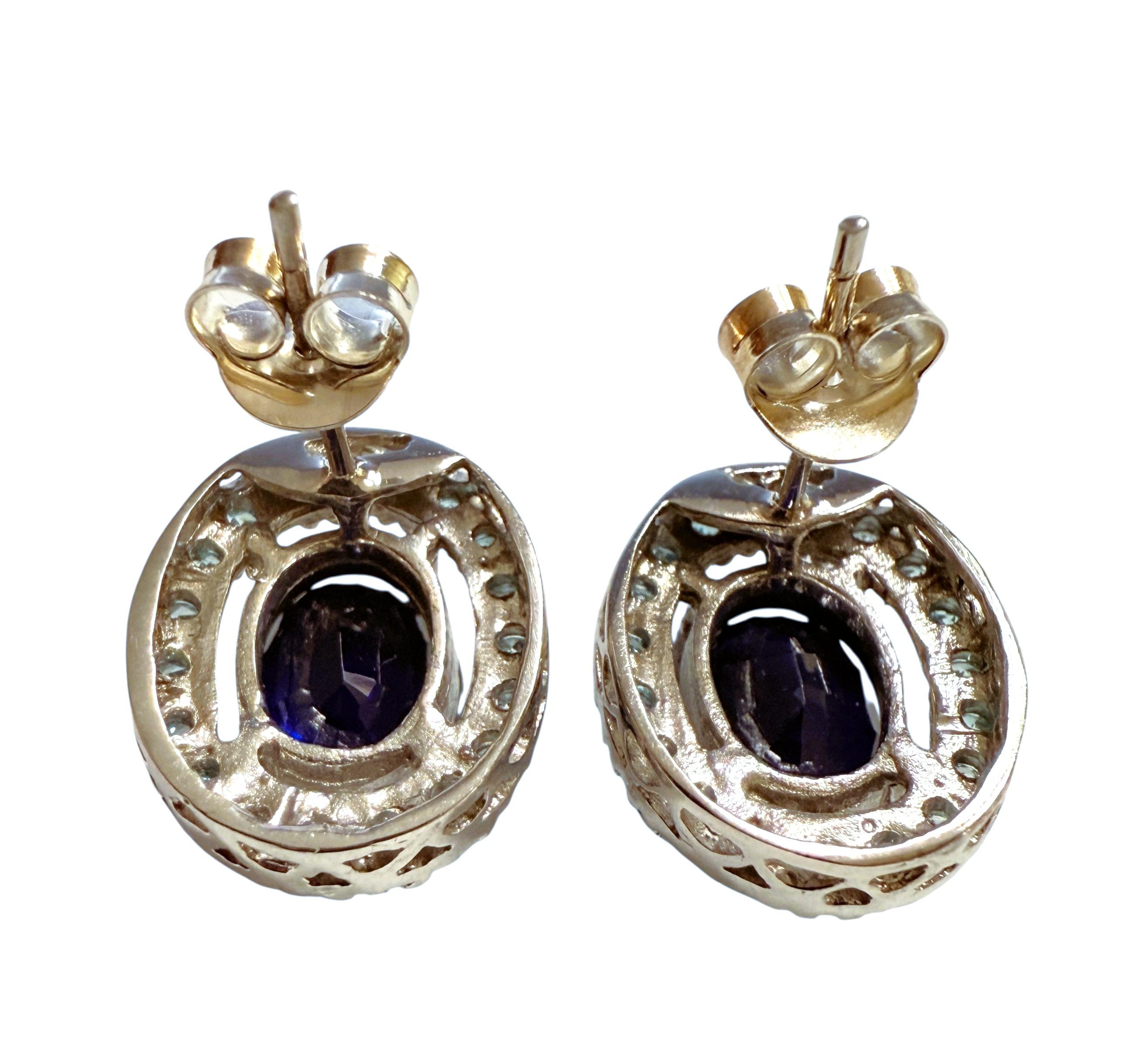 These earrings are just gorgeous!  The stones are from Sri Lanka and are 4.2 carats each.   The oval shaped stones measures 10 x 8 mm and are surrounded by diamond cut aqua blue sapphire stones which makes the earrings just pop. They are post