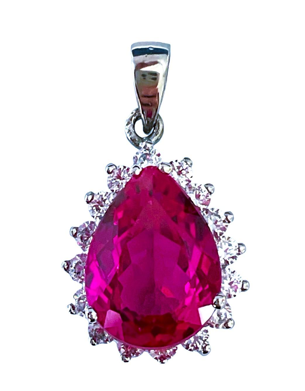 This pendant has such beautiful color!   The stone is from Africa and is just exquisite.  It is a very high quality stone.   It is a Pear cut stone and is 8.7 Ct   The main stone is 15.2 x 11 mm and is surrounded by diamond cut white sapphires.  