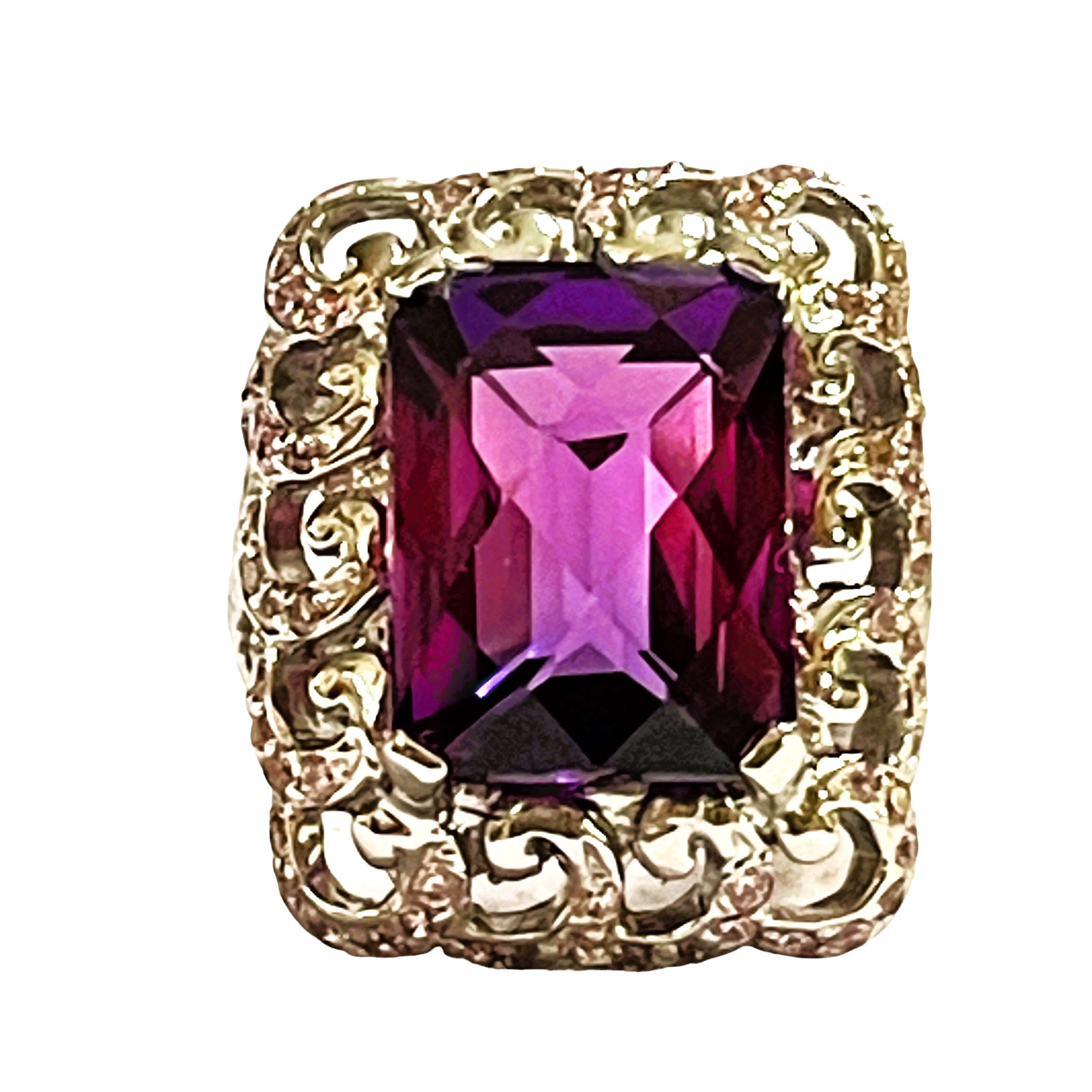 What beautiful color stones in this ring!  The ring is a size 6.25. The stones are from Africa and is just exquisite.  The stone is a fancy cut stone and is 12.80 cts.  They main stones are 13.7 x 10.5 mm..  It is in a beautiful filigree setting The