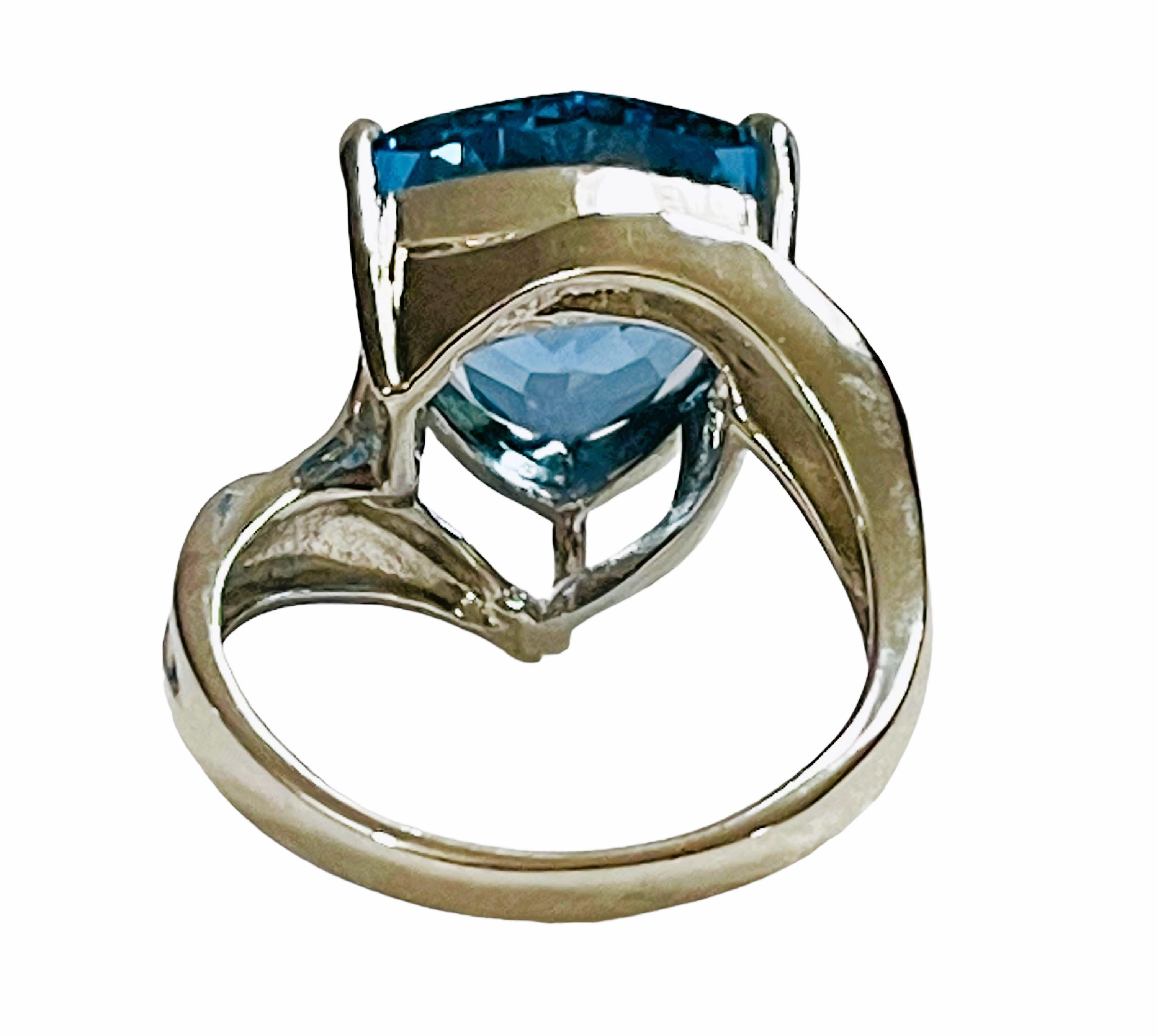 The ring is a size 6.75. It was mined in Africa and is just exquisite. It is a highly rated IF (Internally Flawless) stone.  A very high quality stone. It is an trillion cut stone and is 8.40 Cts.   The main stone is 12.8 mm. It has Blue Sapphires