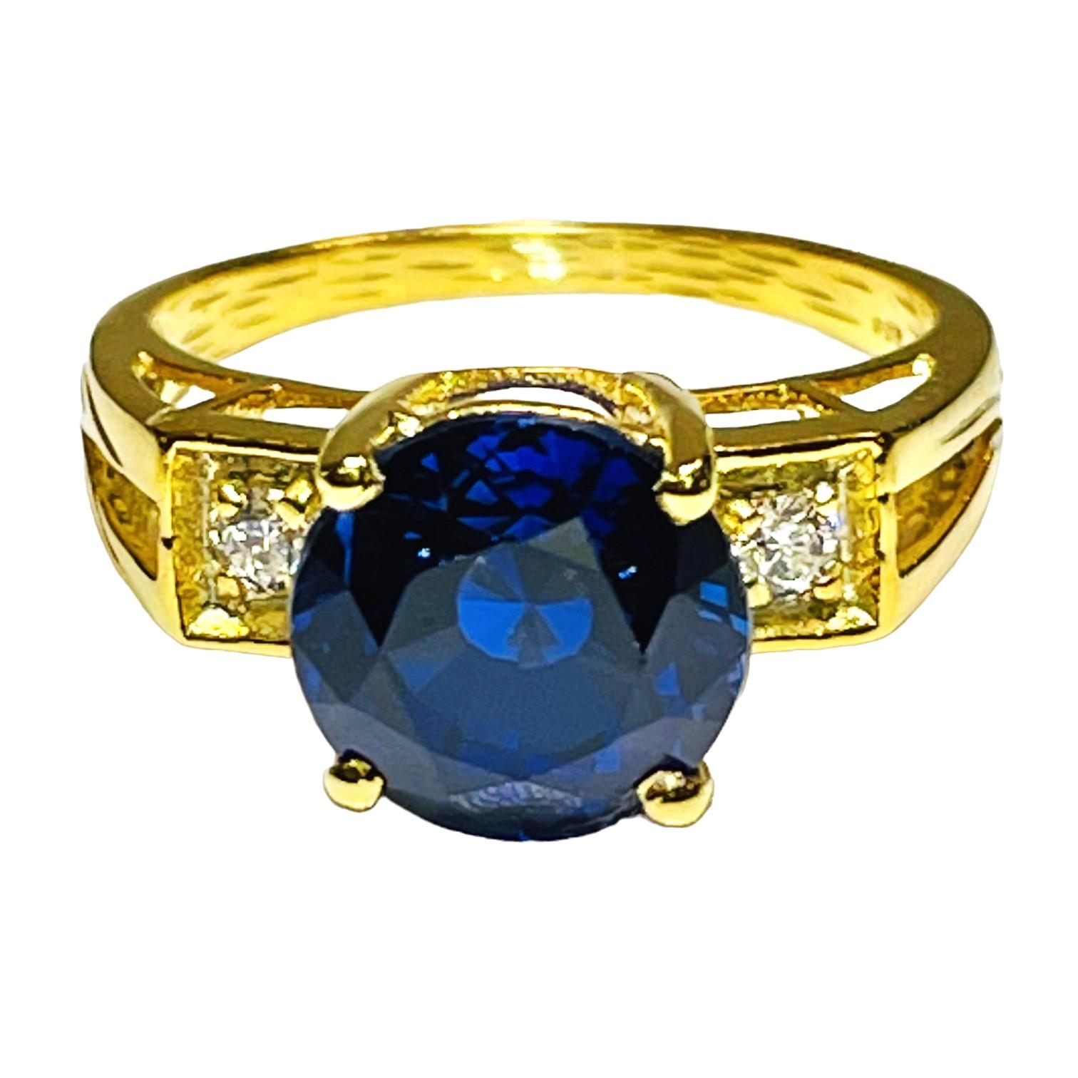 This stone was mined in Africa and is very rich in color.   It is a beautiful round cut stone and is 4.70 Ct   The main stone is 9 mm.  It is flanked by small diamond cut white sapphires.  Very beautiful  indeed.  Sure to get noticed.  The weight in