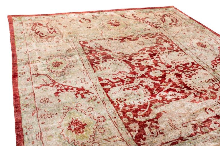 Originating from India, this new Agra silk rug depicts an uncommon modern homage to lesser-known Indian symbolism. Hand knotted in naturally luminous silk, the distinctly wide ivory and red border features depictions of wolves with floral tails,