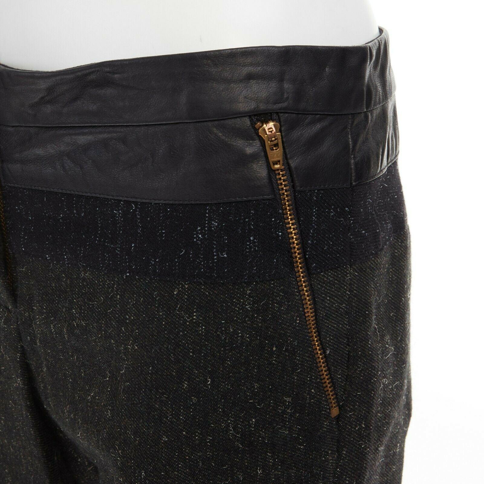new ALC leather waist navy grey wool tweed colorblocked slim fit pants

A.L.C.
Black leather waist detail. Navy and grey wool tweed fabric. Colorblocked detail at waist. Dual zipper pocket. Concealed hook bar zip fly closure. Cropped length. Slim