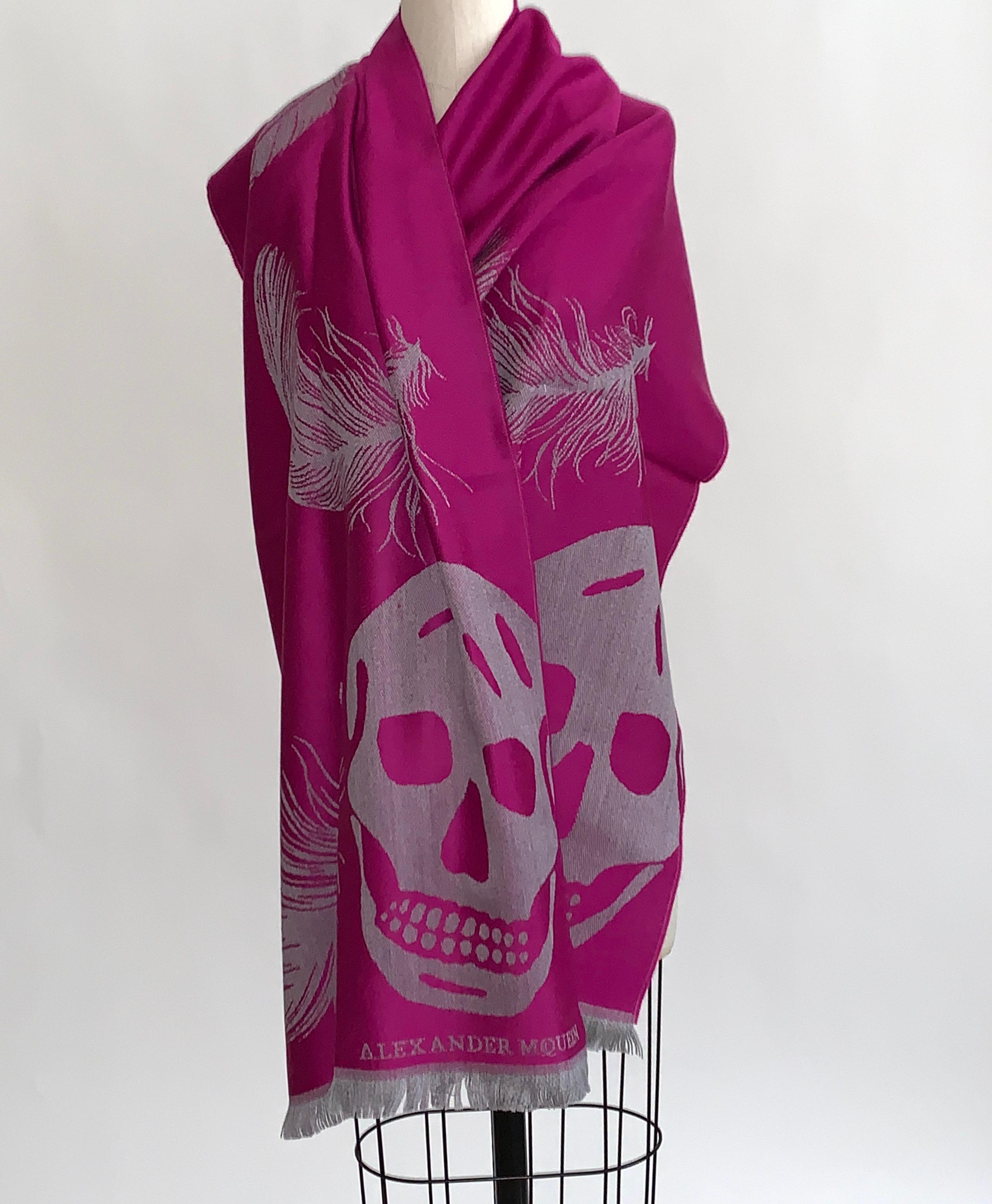 New Alexander McQueen large fuchsia and grey scarf featuring feathers throughout and a large skull at each end. Super soft wool. Light fringe at ends. Signed Alexander McQueen at one bottom corner.

Purchased directly from McQueen store.

100%