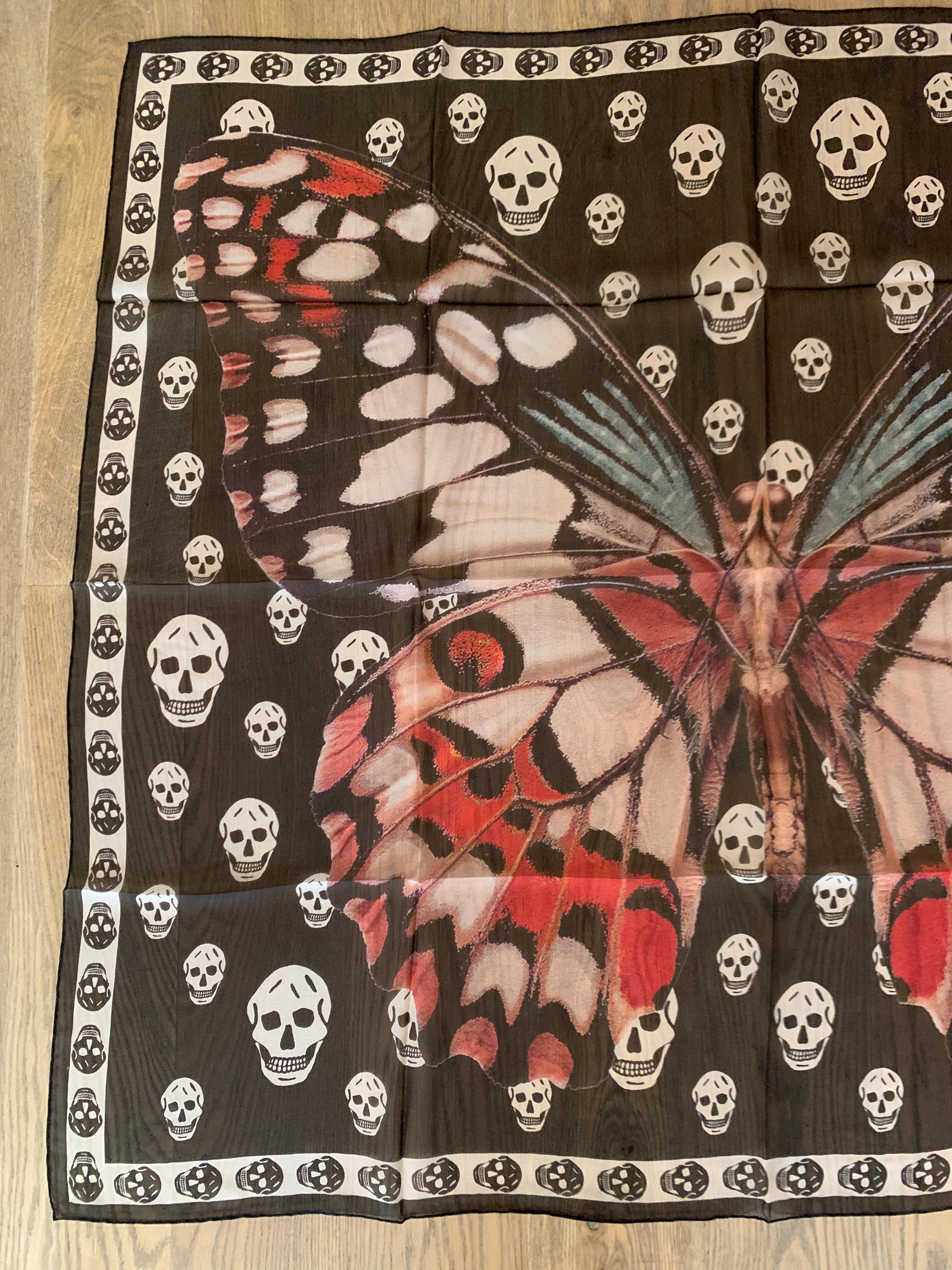 New Alexander McQueen large semi-sheer black scarf featuring giant butterfly or moth with black skulls print throughout background. Signed Alexander McQueen in logo at bottom corner. 

Purchased directly from McQueen store.

100%