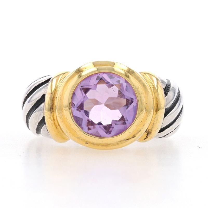 This pretty new ring features a round cut genuine amethyst displayed in a gold plated bezel setting atop a rope etched silver band. The two carat faceted amethyst has a lovely purple hue. The inside of the band is stamped 925.

This ring is a size
