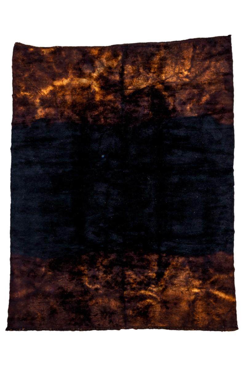The near black field is open across the middle of this coarsely woven carpet, bounded at the ends by unbalanced, smoky vaporous designs in straw. The end decorations seem to more with a gentle breeze, blowing in and out. As new condition. Measures: