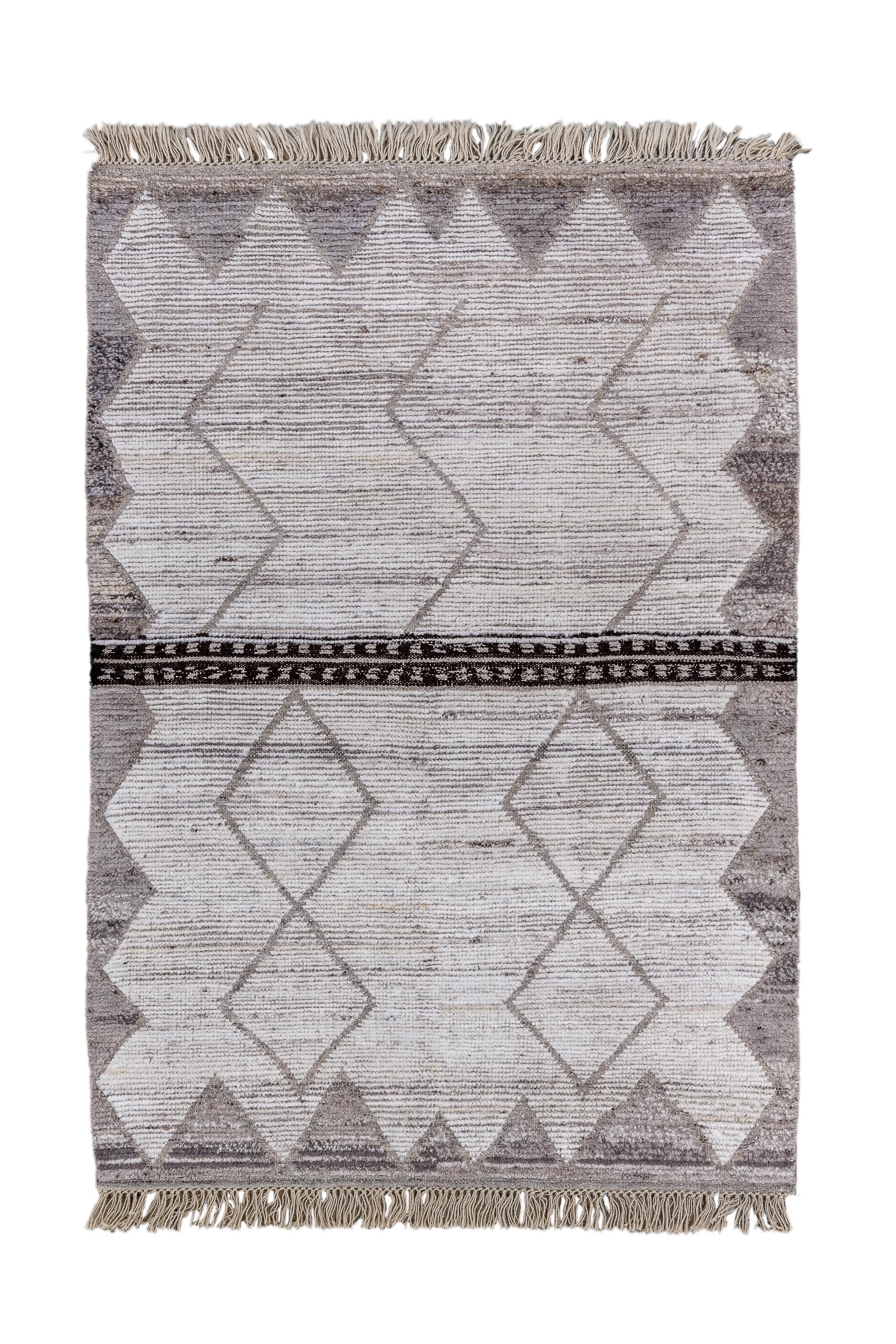 Long pile Turkish rustic Tulu rugs are a relatively recent innovation. This one is very coarsely woven, with a flat pile and numerous wefts. The ecru beige field shows a strong horizontal, bipartite band, dividing zig-zag and lozenge decorated