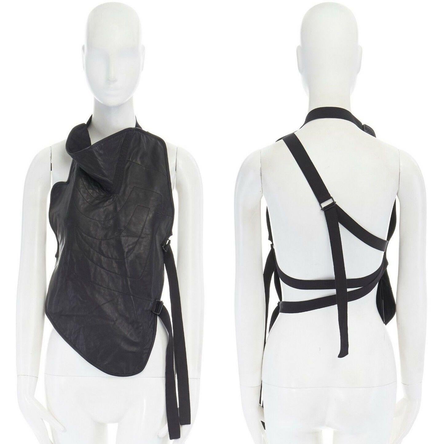 new ANN DEMEULEMEESTER black leather draped neck stitch strappy harness top M
ANN DEMEULEMEESTER
Black leather. Draped neckline. Tonal stitching detail. Sleeveless. 
Front patch vest design. Cotton and D-ring multi-strap bondage back. 
Fully lined
