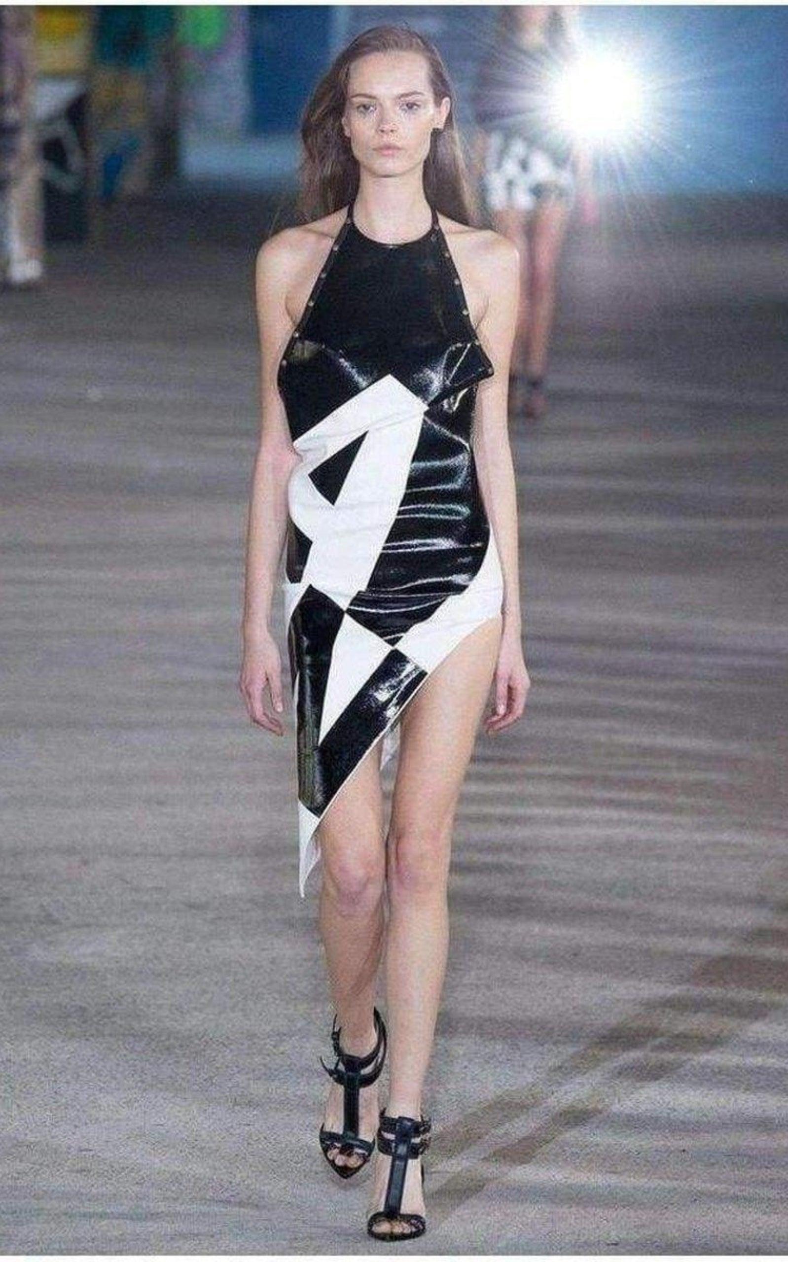 ANTHONY VACCARELLO collectable dress from the Runway Fall Winter 2015 - BRAND NEW

Halter neck with buckle closure. 
Open back. 
Patent leather effect black coated print. 
Asymmetrical hem. 
Grosgrain trim with metal eyelets. 
Unlined. 
80% EA 20%