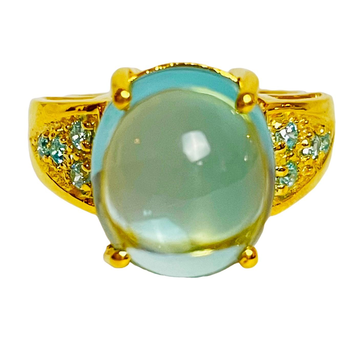 The stone in this ring is just stunning!  It is 7.80 carats.  It is 13 x 11 mm.  The color is amazing!  It's complemented by smaller aquamarine cut stones on the band.  If blue is a calming color, well, this is the ring for you.  It's like staring
