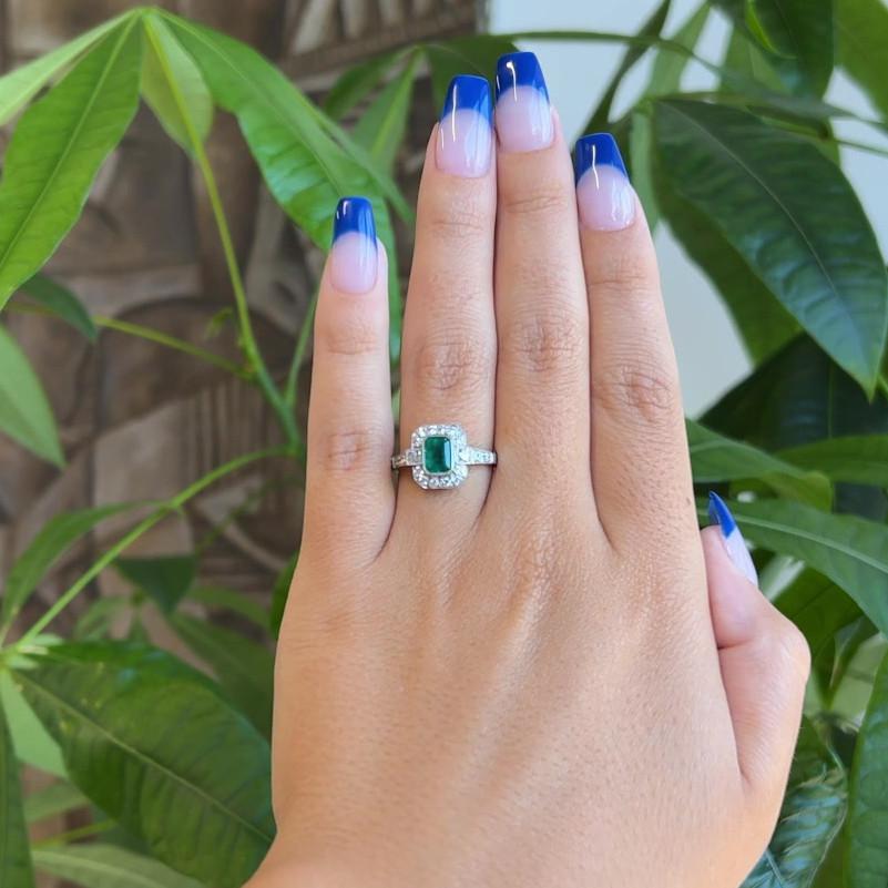 One Art Deco Inspired Emerald Diamond Platinum Ring. Featuring one rectangular step cut emerald of 0.70 carat. Accented by 18 old European cut diamonds with a total weight of approximately 0.45 carat, graded near-colorless, VS-SI clarity, and two