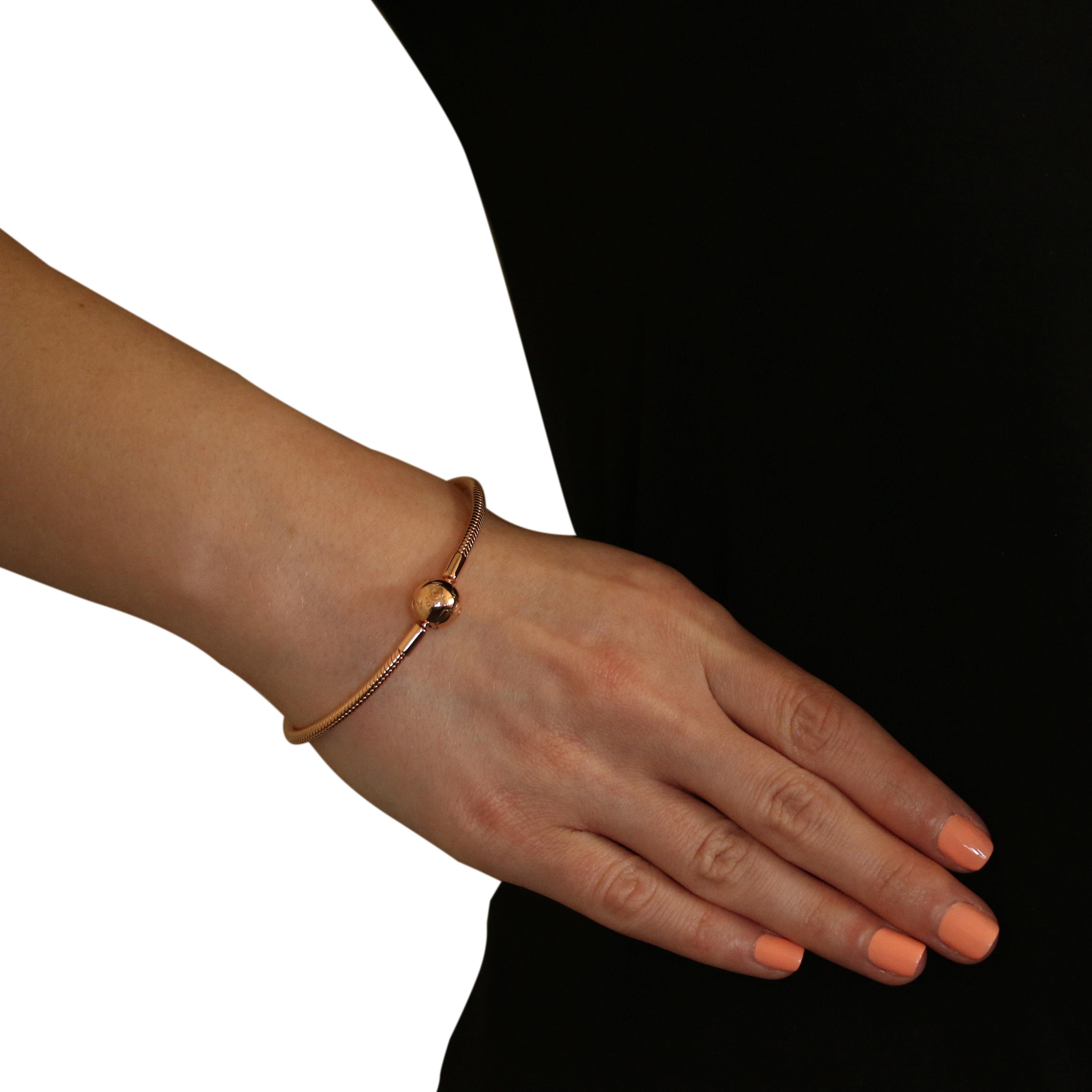 This NEW piece is guaranteed 100% authentic PANDORA, as we recently bought out an authorized PANDORA retailer.

Brand: Pandora
Number: 580728
Title: Pandora Rose Smooth Clasp Charm Bracelet

Metal Content: 14k Rose Gold Plated Sterling