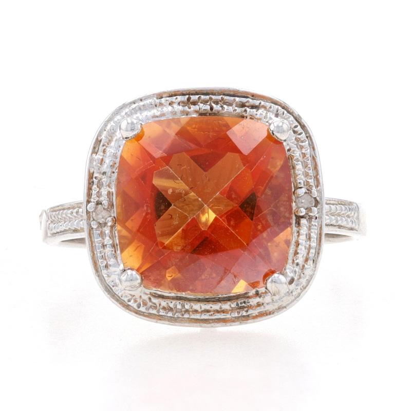 This stunning ring displays a deep orange cushion cut genuine azotic topaz. The solitaire has a 6.90 carat weight and is framed by bead accenting. The bead work is set with two small single cut natural diamonds that have a 0.03 carat weight, I2