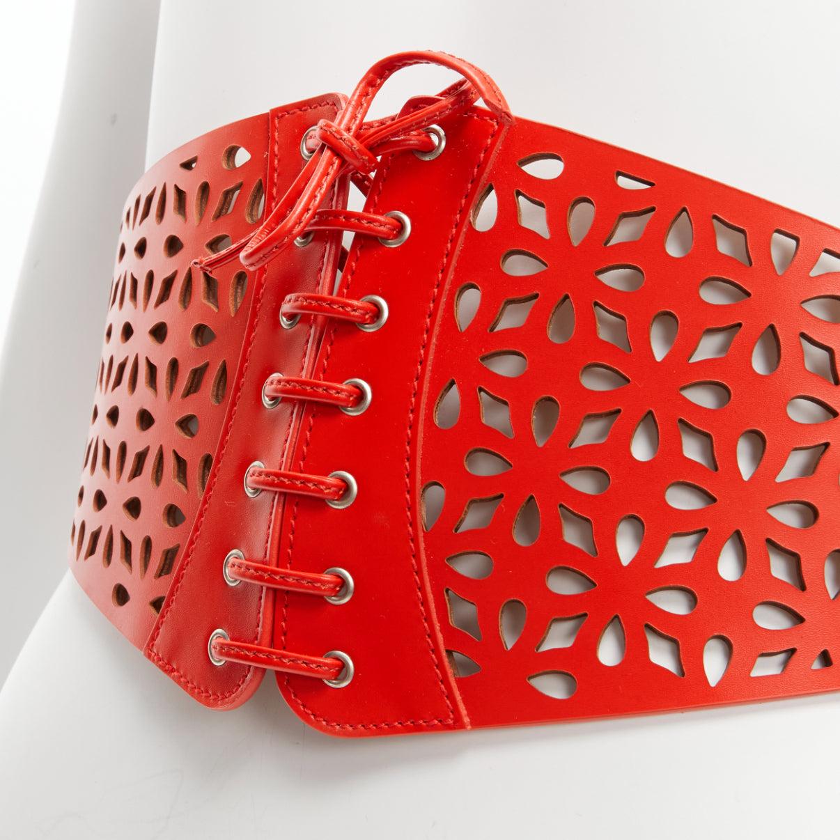 new AZZEDINE ALAIA red laser cut leather laced corset waist belt 70cm
Reference: BSHW/A00138
Brand: Alaia
Designer: Azzedine Alaia
Material: Leather
Color: Red
Pattern: Solid
Closure: Belt
Lining: Beige Leather
Extra Details: Belt buckle closure