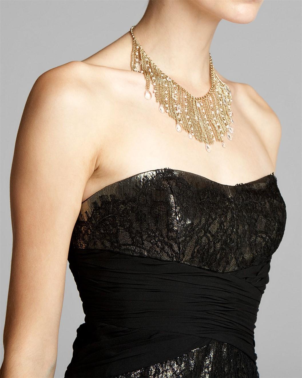 Badgley Mischka Dress
Brand New with Tags
Black and Gold Lame' Dress
Strapless with Boning at Bodice for Support
Black Lace over Gold Lame'
Fully Lined
Center Back Zipper Closure
Shell: 63% Silk, 37% Metallic 
Lining: 100% Polyester
We are happy to