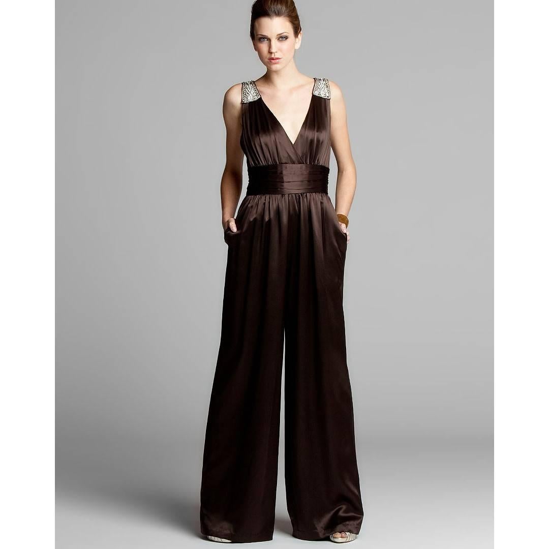 Badgley Mischka Jumpsuit
Stunning!
Size: 6
* 100% Silk
* Rhinestone jewel details on shoulders
* Banded waist with horizontal pleats 
* Center back zipper closure
* Flowy loose fit through legs
* Two Hidden Side Pockets
* Chocolate Brown
We are