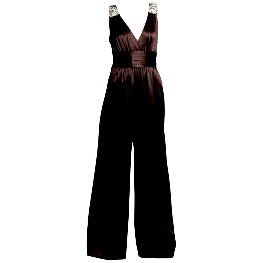 Badgley Mischka Jumpsuit
Stunning!
Size: 2
* 100% Silk
* Rhinestone jewel details on shoulders
* Banded waist with horizontal pleats 
* Center back zipper closure
* Flowy loose fit through legs
* Two Hidden Side Pockets
* Chocolate Brown

