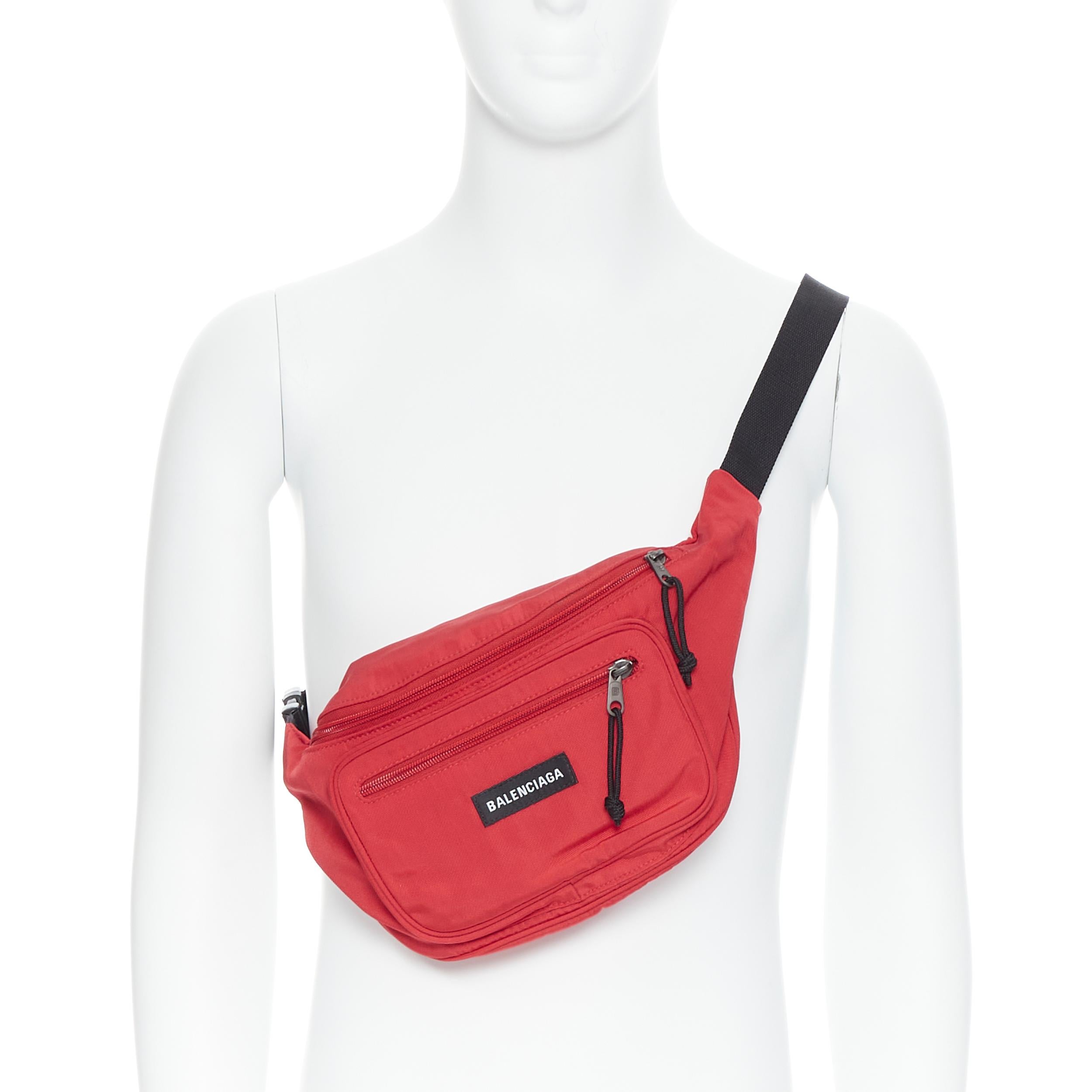 new BALENCIAGA DEMNA red logo dual pocket nylon black waist belt crossbody bag 
Reference: TGAS/B00183 
Brand: Balenciaga 
Designer: Demna Gvasalia 
Material: Nylon 
Color: Red 
Pattern: Solid 
Closure: Zip 
Made in: Italy 

CONDITION: 
Condition: