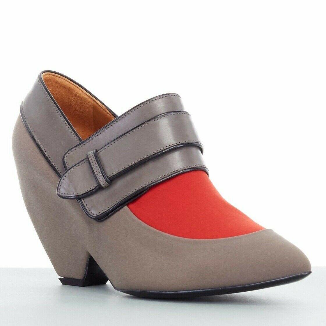 new BALENCIAGA GHESQUIERE AW12 grey orange pointy wedge heel shoes EU38 US8 UK5
BALENCIAGA by NICHOLAS GHESQUIERE
FROM THE FALL WINTER 2012 COLLECTION
Taupe grey and burnt orange scuba . 
Pointed toe . 
Rounded wedge . 
Grey leather strap across