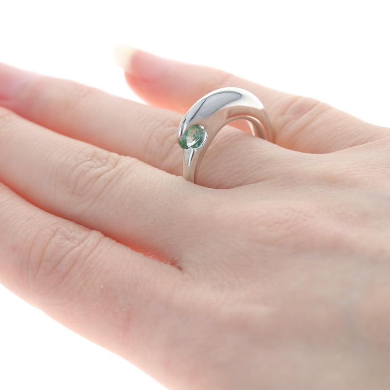 This ring retails at $200

This ring is a size 7 1/2 - 7 3/4. 

Metal Content: Sterling Silver
Finish: Polished

Stone Information:
Genuine Topaz - 
Treatment: Coated
Color: Green
Cut: Round  

Face Height (north to south): 3/16