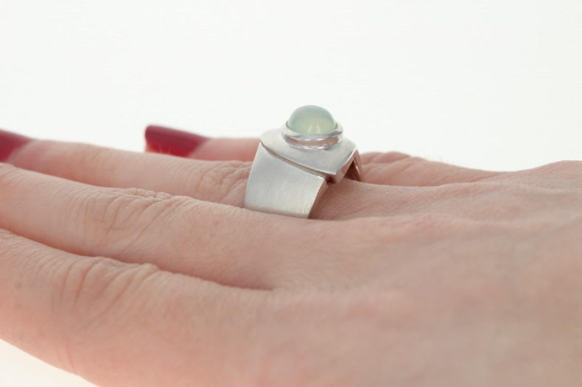 This ring retails at $350 
This ring is a size 6 3/4. Please contact for additional sizing options.
Metal Content: Sterling Silver
Finish: Brushed / Satin
Stone: Moonstone - Light Green
Face Height (north to south): 21/32