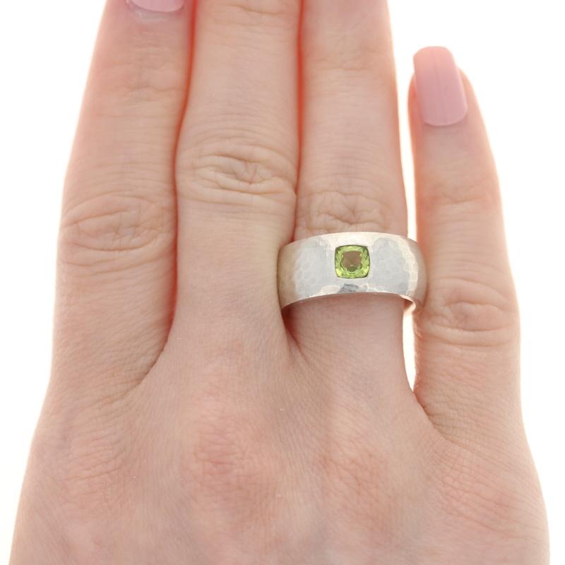 This ring retails at $385
This ring is a size 7 1/4 - 7 1/2. Please contact for additional sizing options.
Metal Content: Sterling Silver
Finish: Brush, Hammered
Stone:  Peridot
Face Height (north to south): 11/32